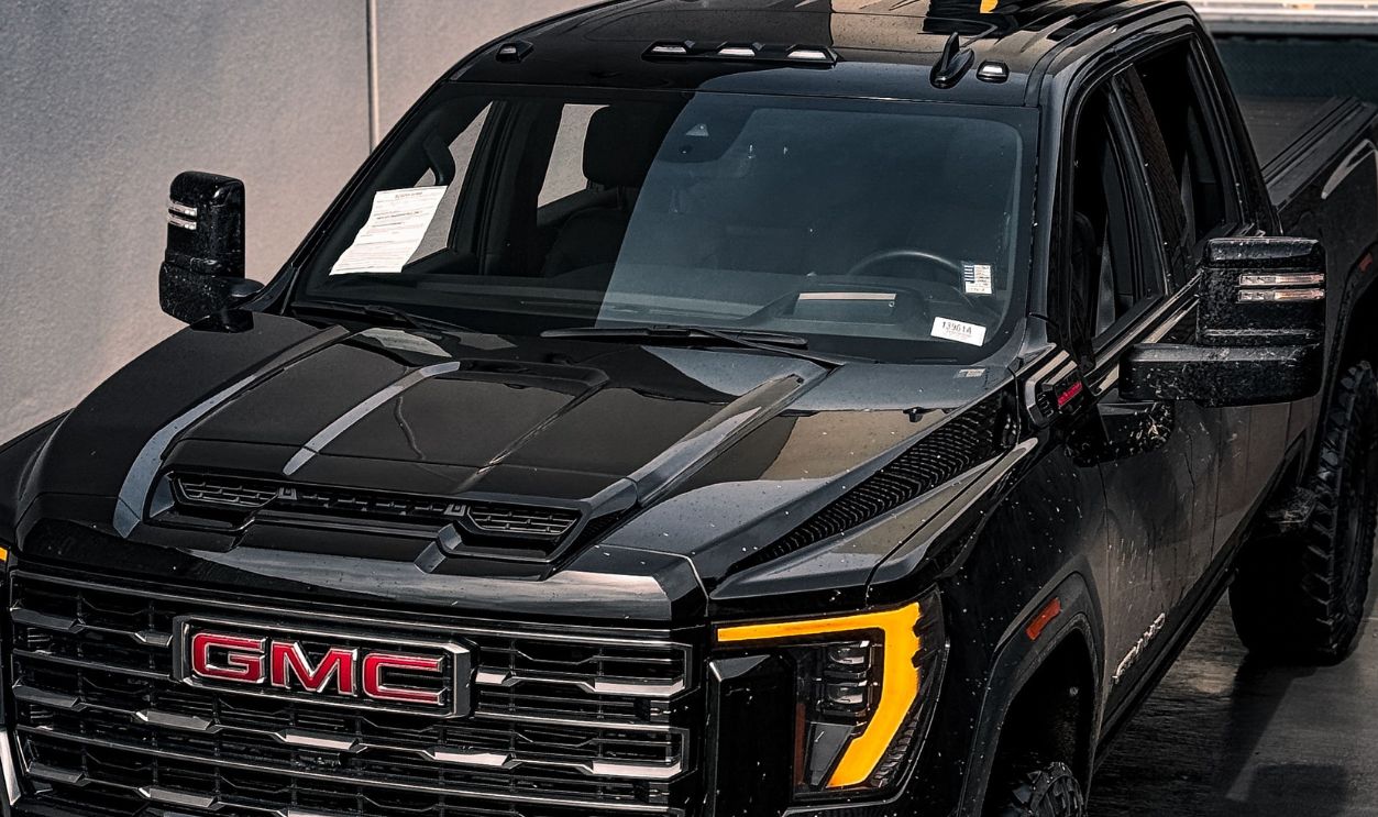 A stylish black GMC truck parked in an urban garage, showcasing modern design