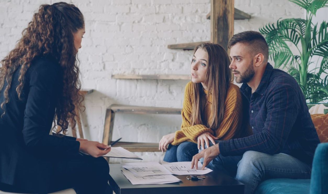 Young couple consulting with a business advisor in a modern office setting