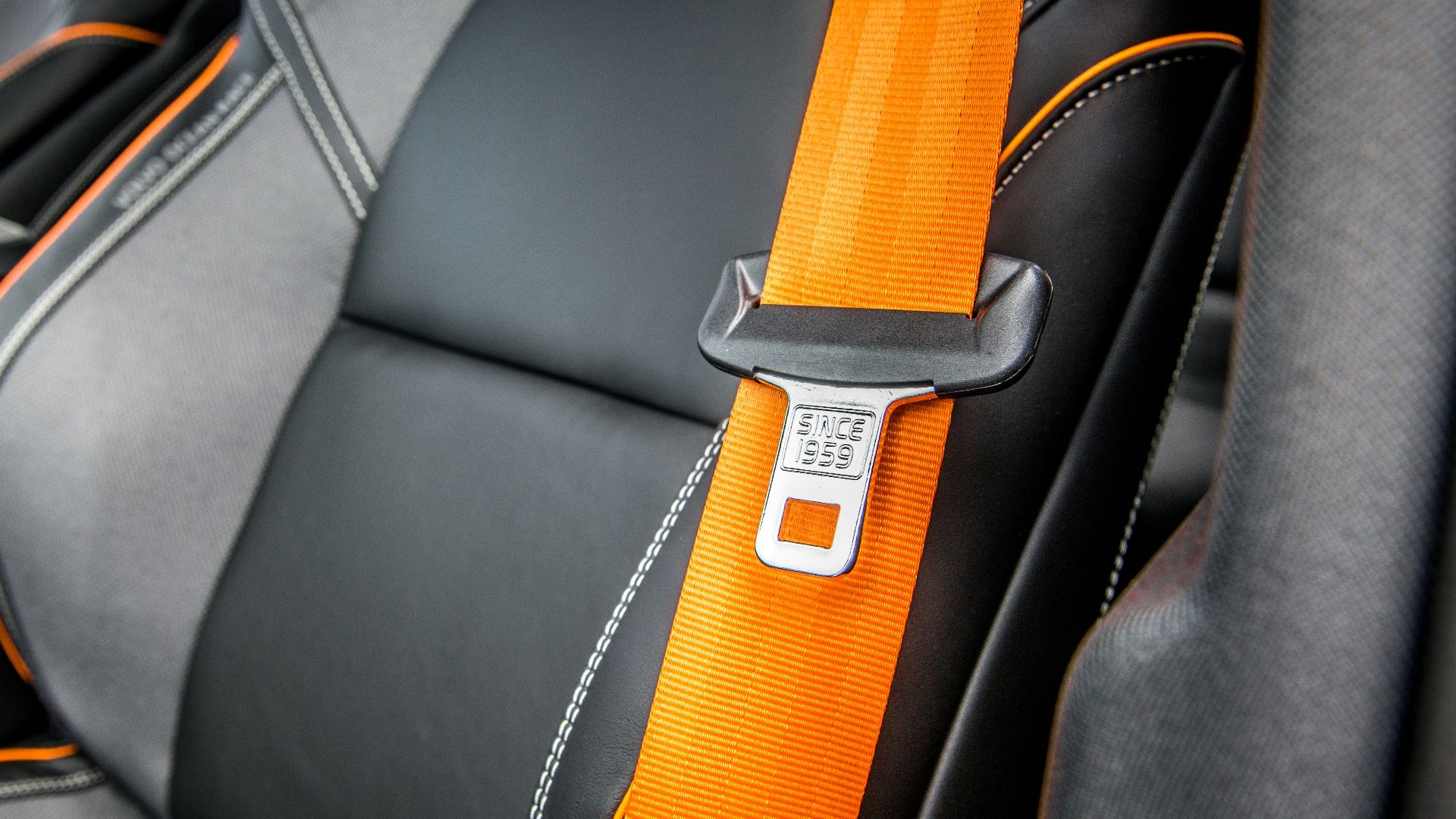 orange and white belt on black leather seat