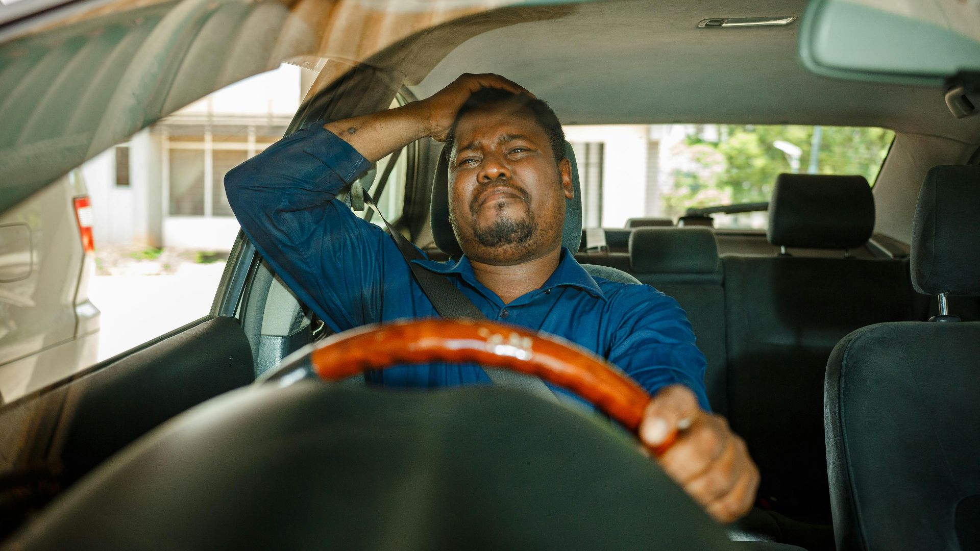 a man sitting in the driver's seat of a car