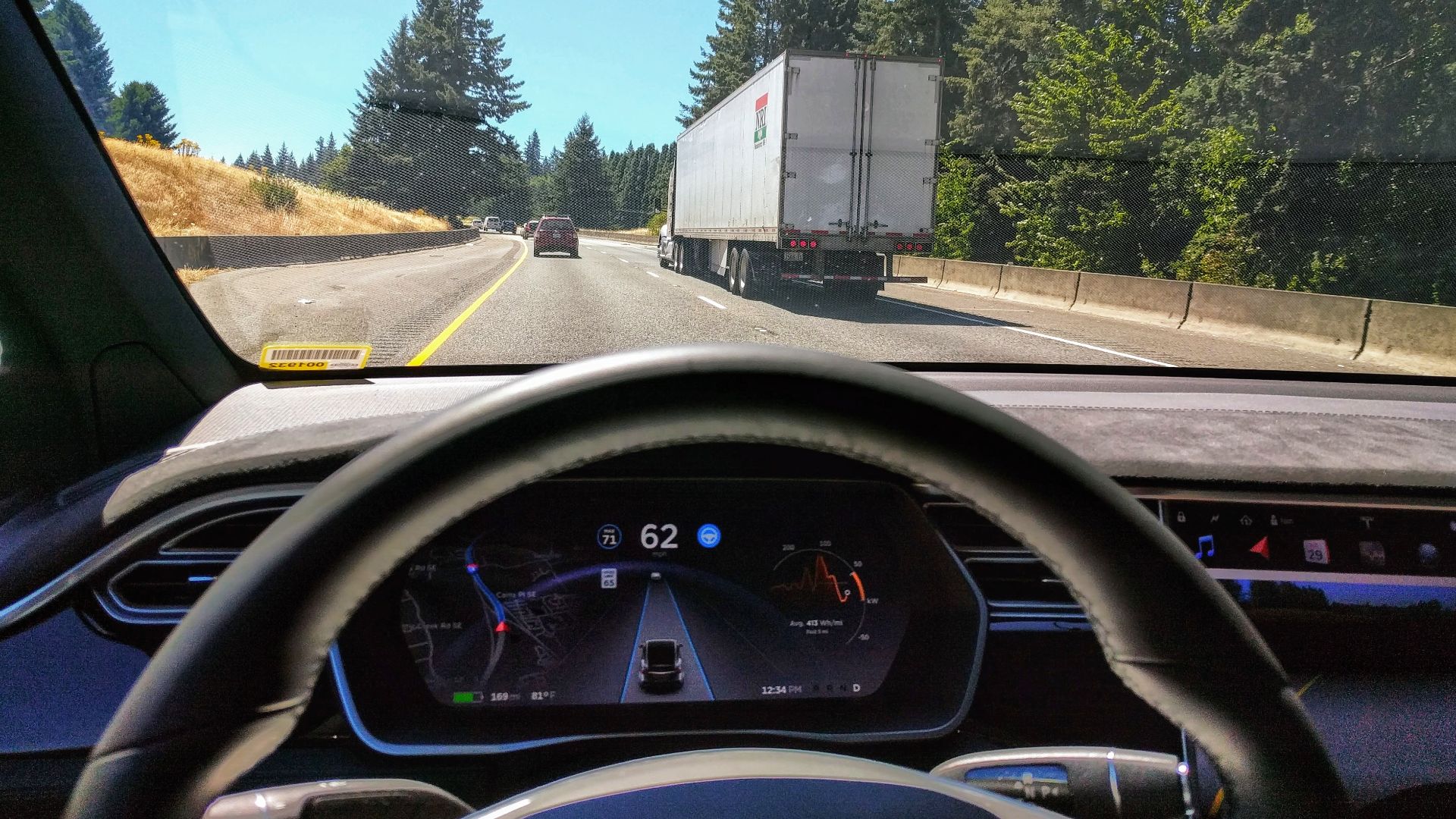 Driving in traffic with Tesla's autopilot controlling distance from the lead car and centering the vehicle in the lane.Vehicle is a 2017 Model X 75D with dark interior.
