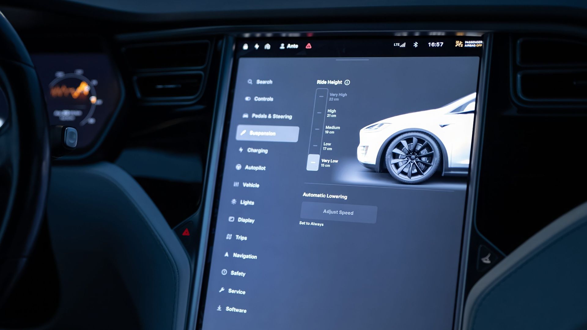 Tesla car interior showcasing advanced touchscreen display and steering controls.