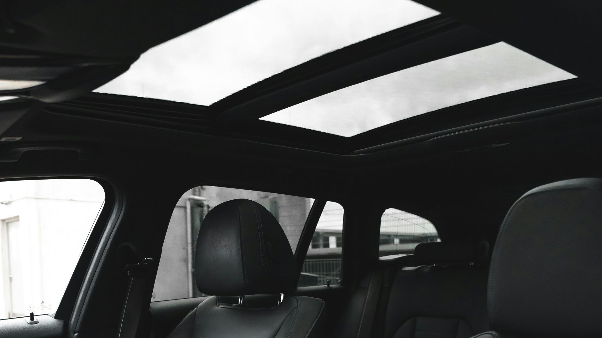 the interior of a car with black leather seats