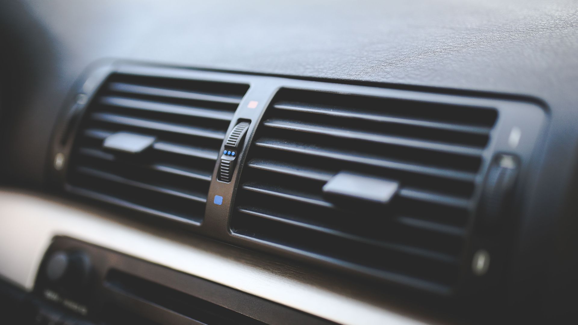 Detailed view of air conditioning vents in the interior of a BMW car, showcasing modern automotive design.