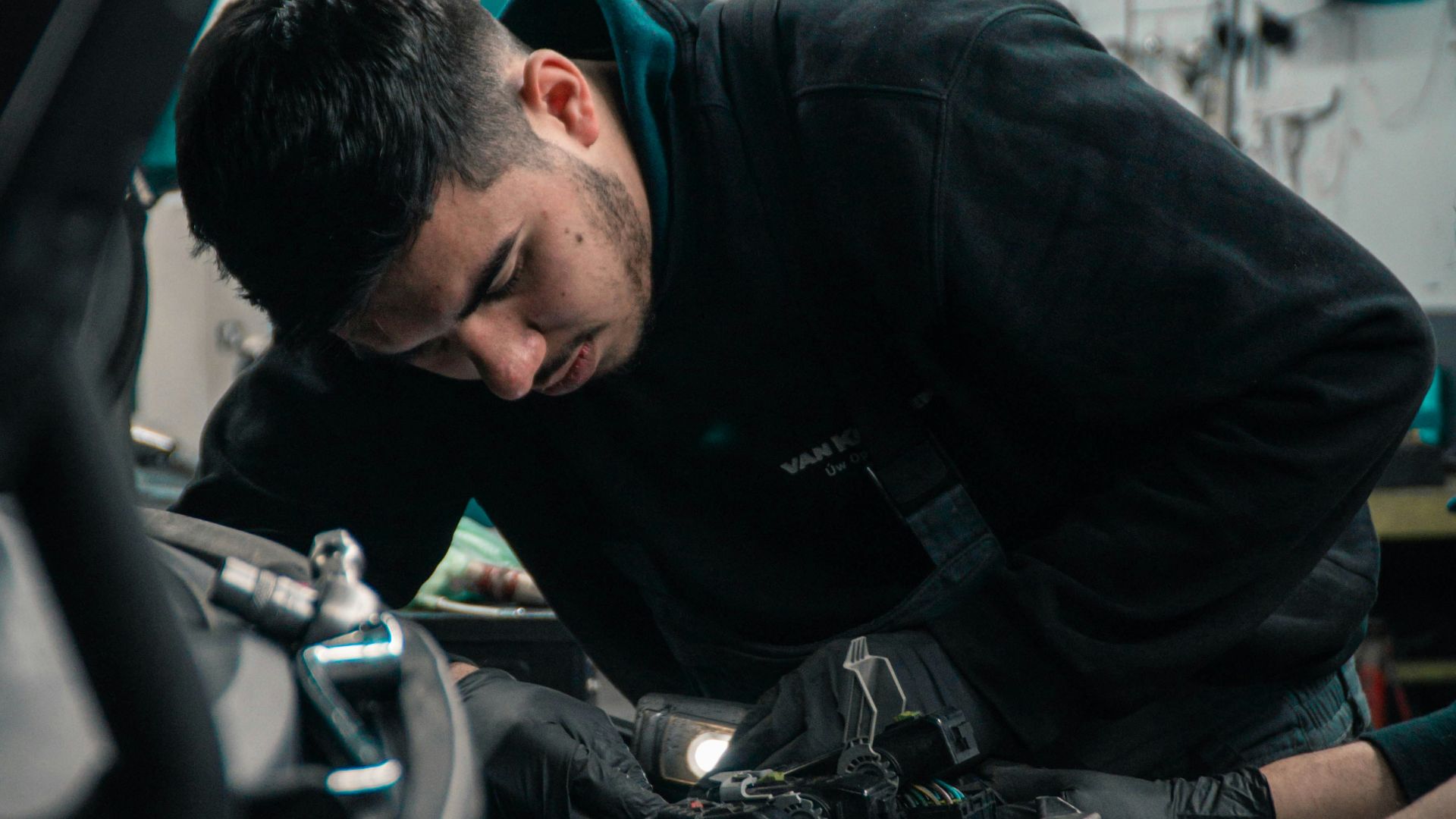 mechanic working on car engine