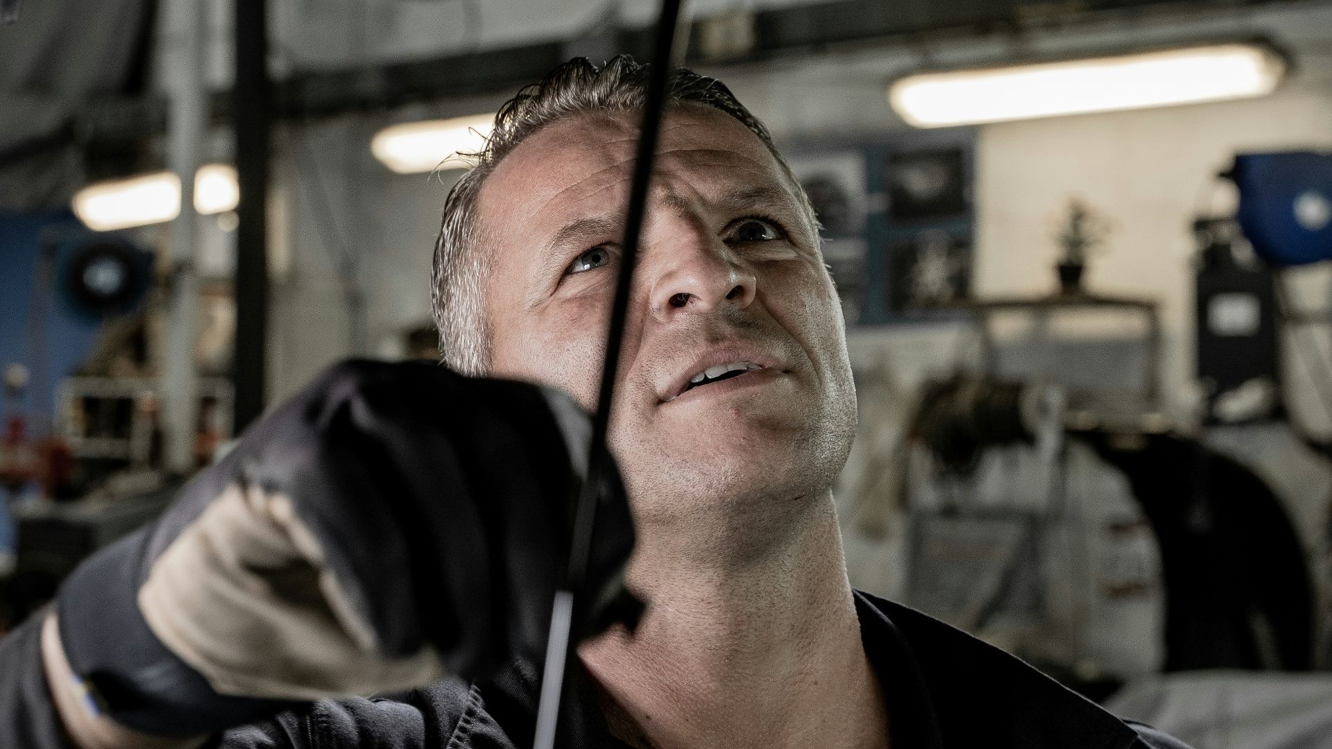 a man working on a car in a garage