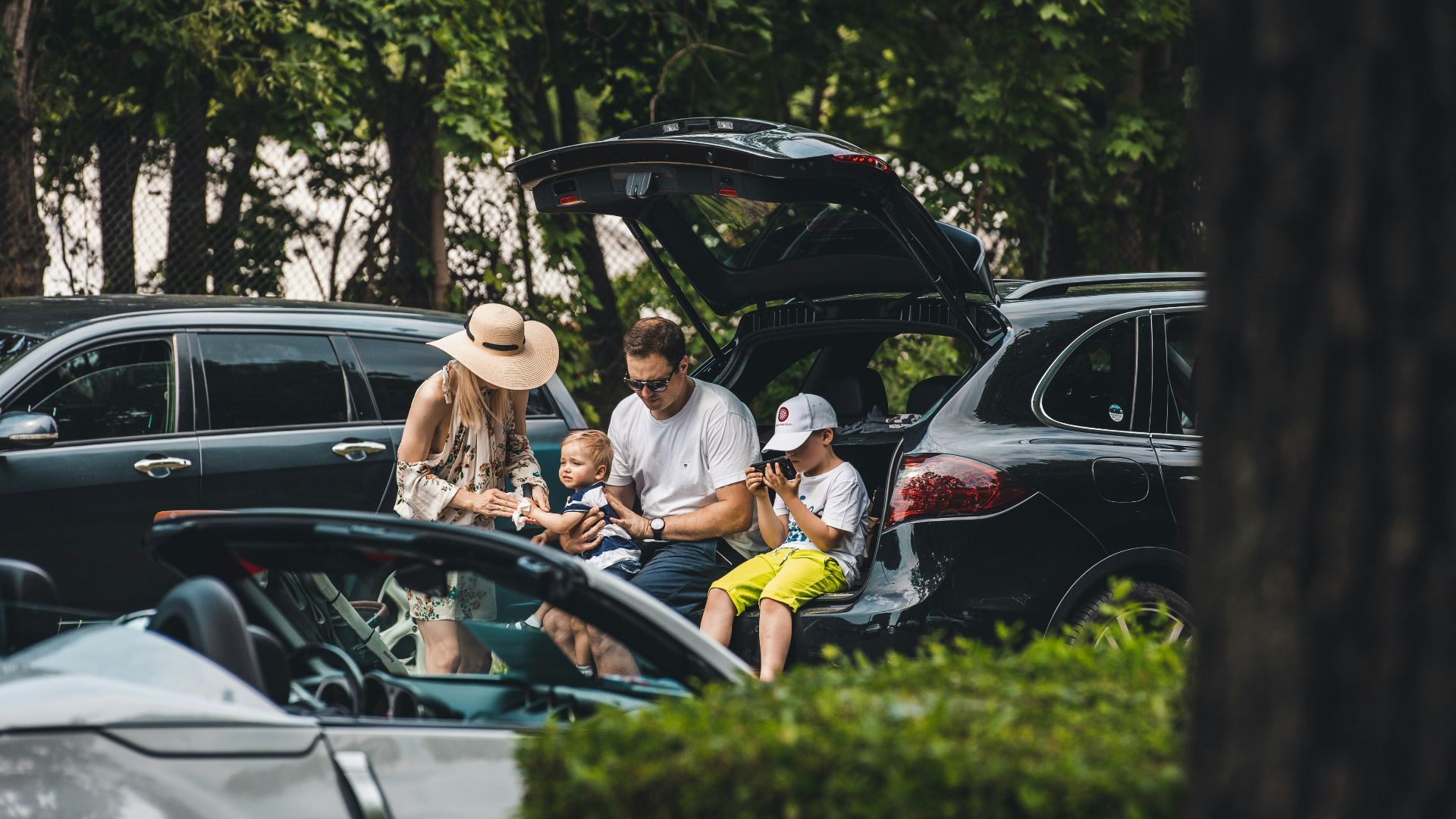 a group of people sitting in the trunk of a car