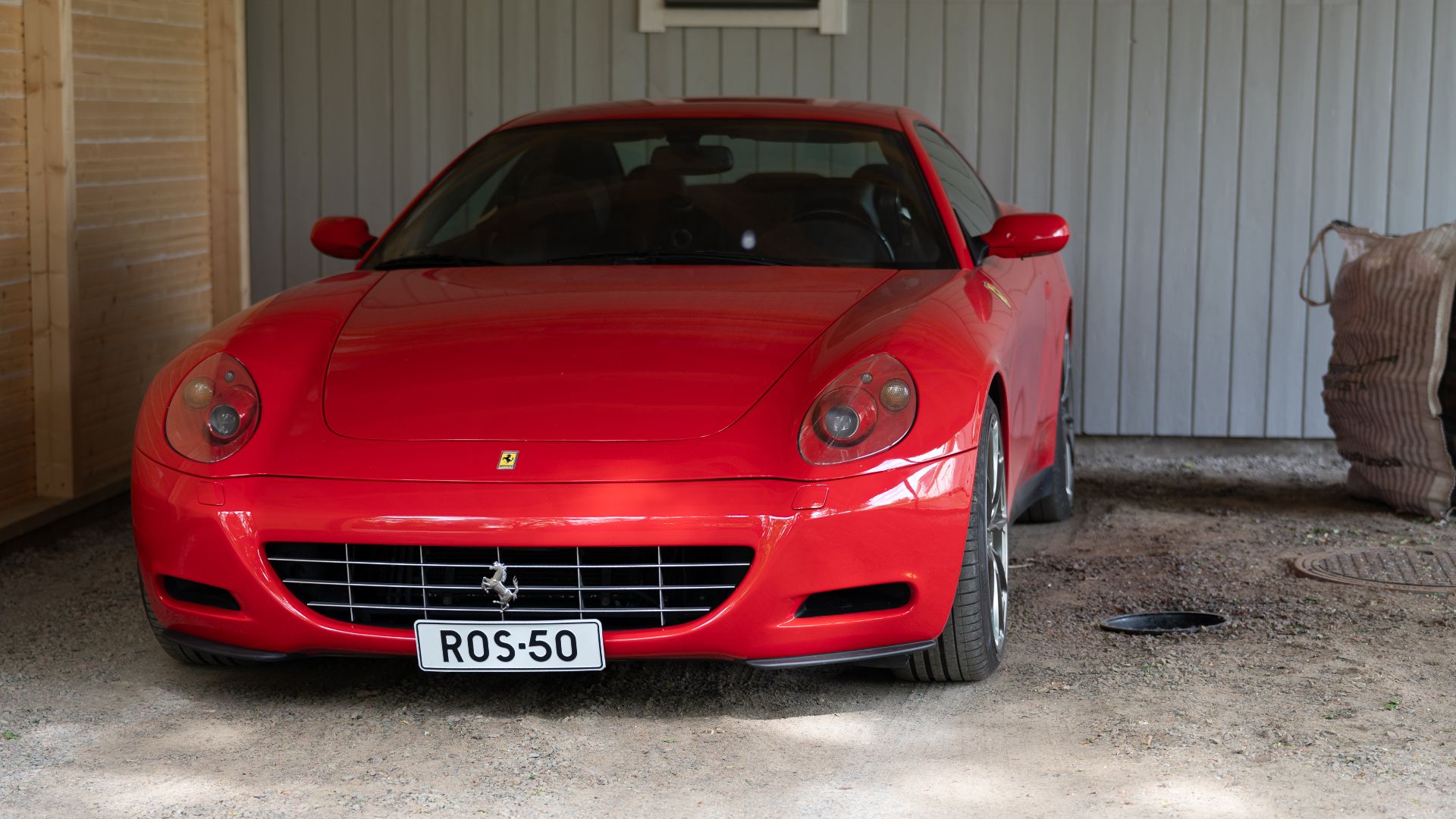 Red Ferrari parked in garage