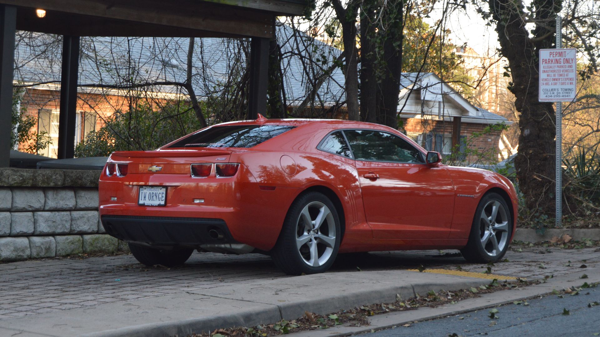 An orange car with related vanity plate, parked on Montebello Circle in Charlottesville, Virginia, United States.
