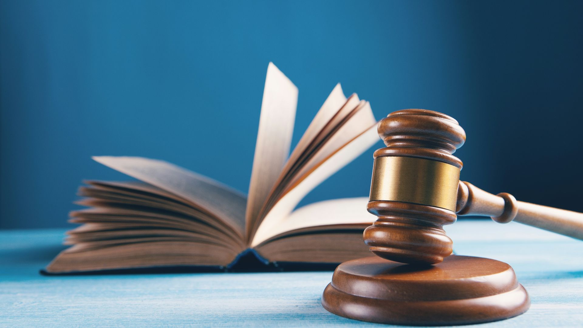 judges gavel and open book on table