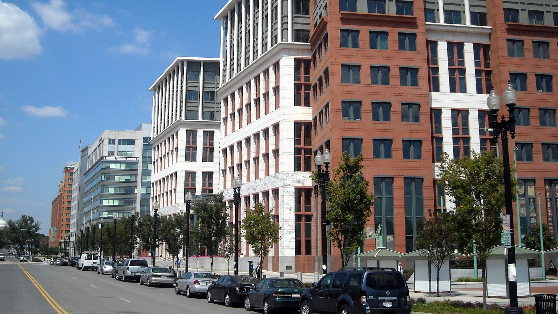 The United States Department of Transportation headquarters, located at 1200 New Jersey Avenue, S.E., in the Navy Yard neighborhood of Washington, D.C.  The dome of the United States Capitol is visible in the background.