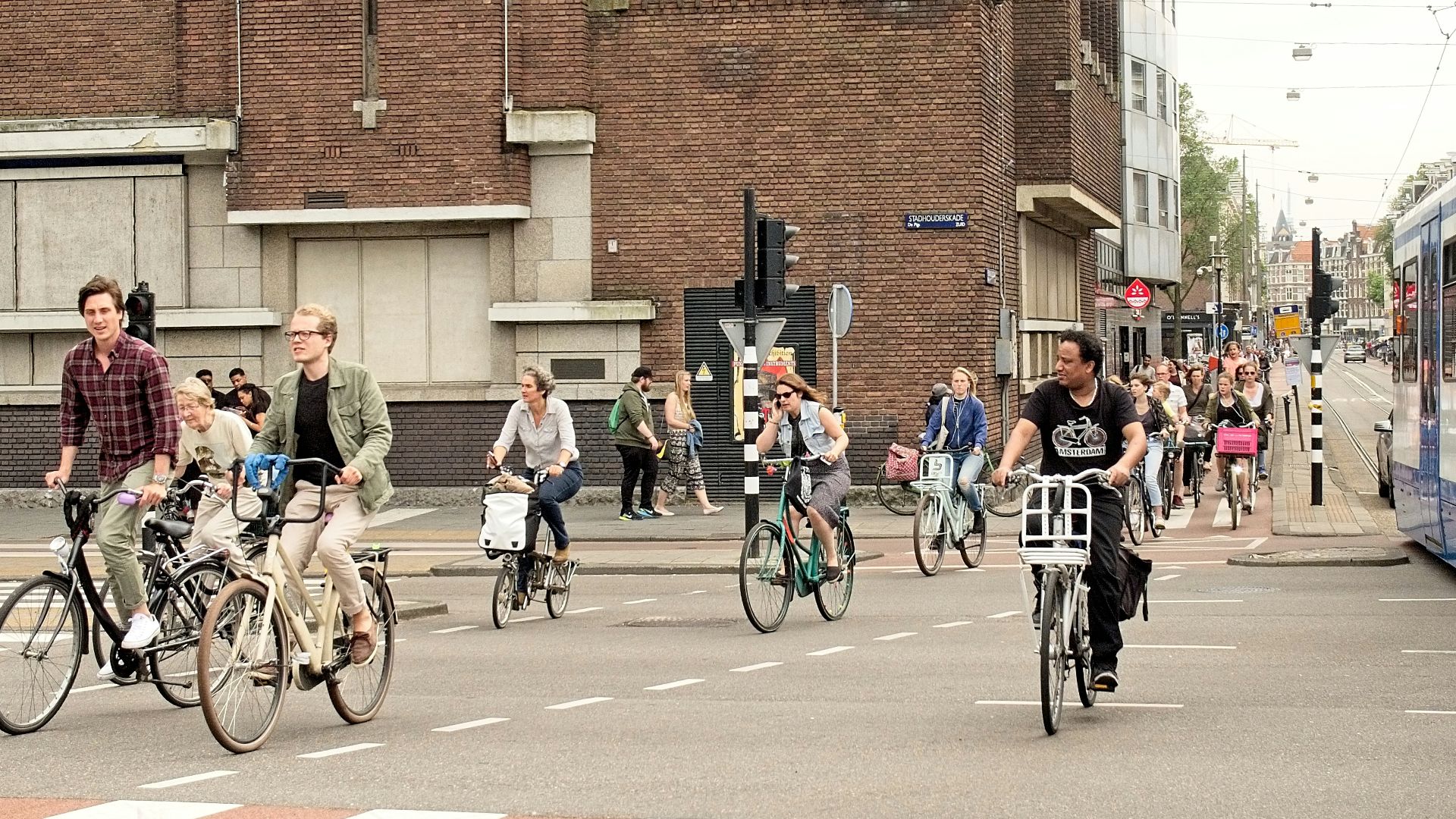 people riding bicycles on road during daytime
