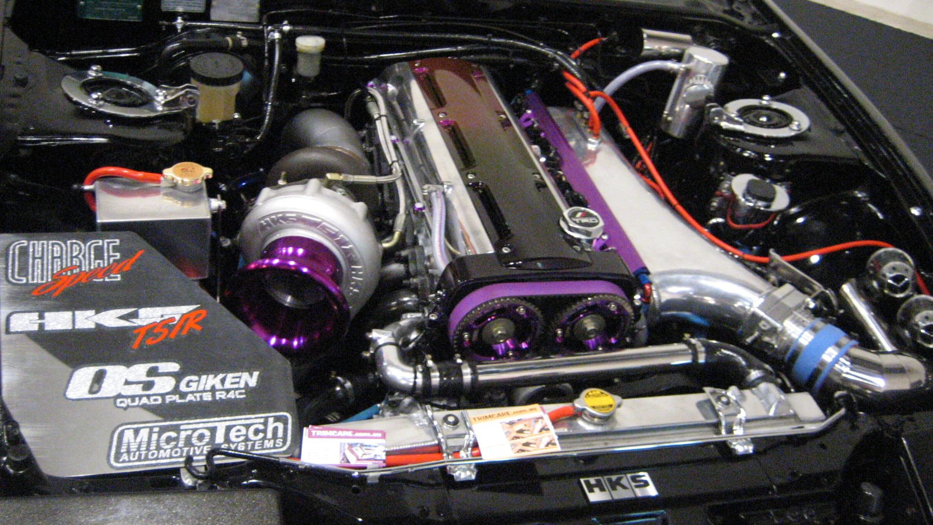 A highly modified engine bay with a visible air-intake, turbocharger and intercooler. I took this photo at the 2007 Perth Auto Salon Motor Show