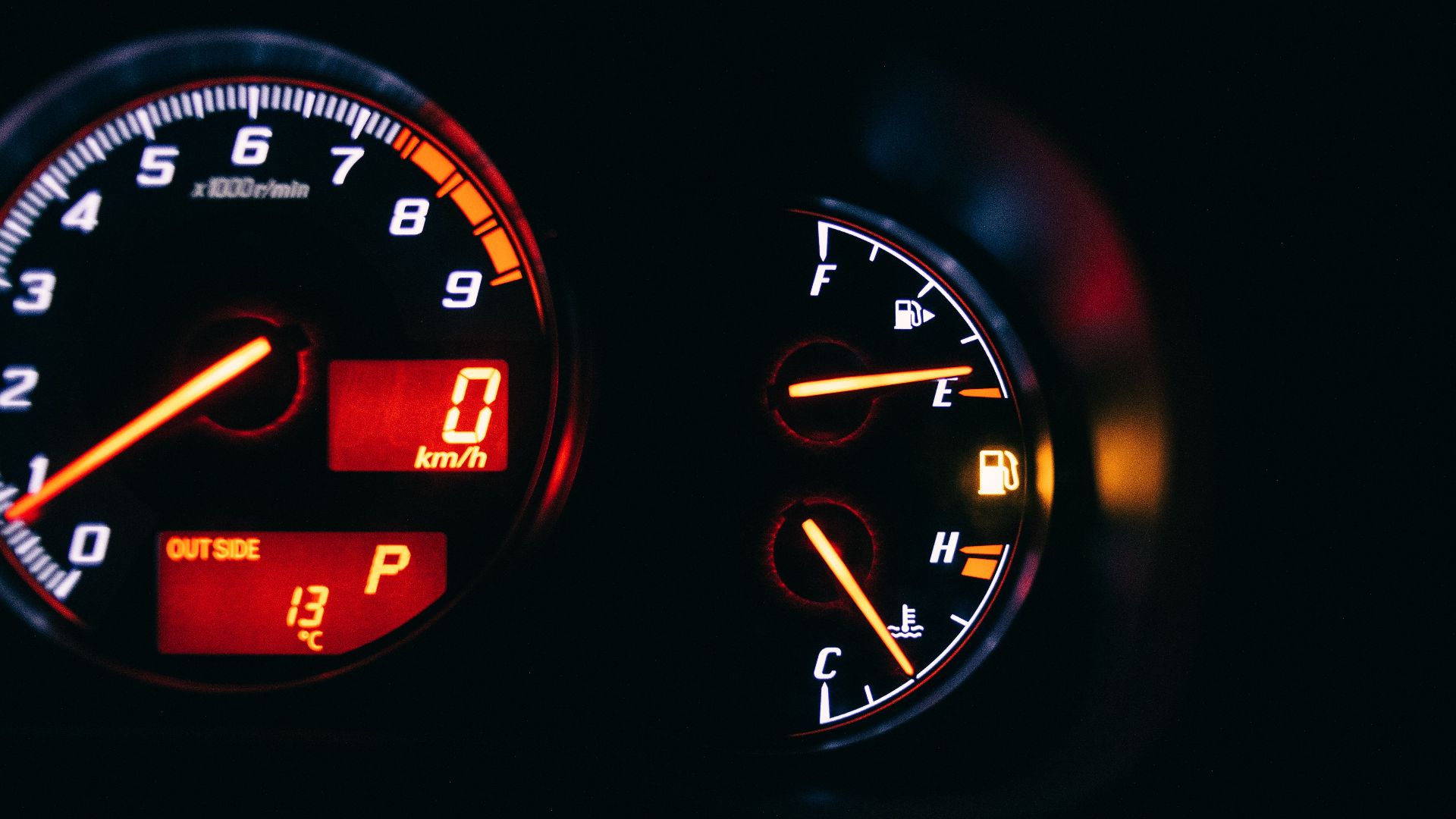 Modern control and measuring devices with arrows indicating numbers and letters on scales in automobile on black background