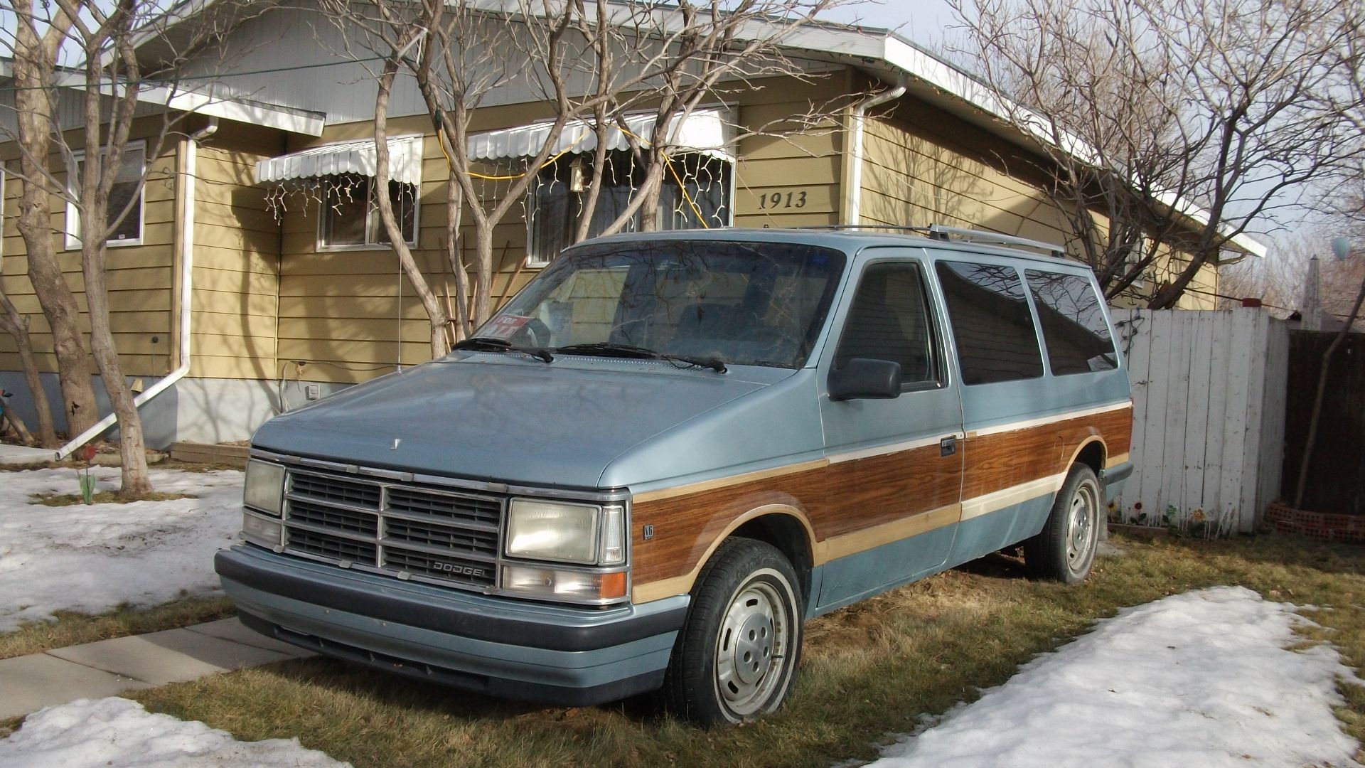 Dodge Caravan with the fake wood paneling.