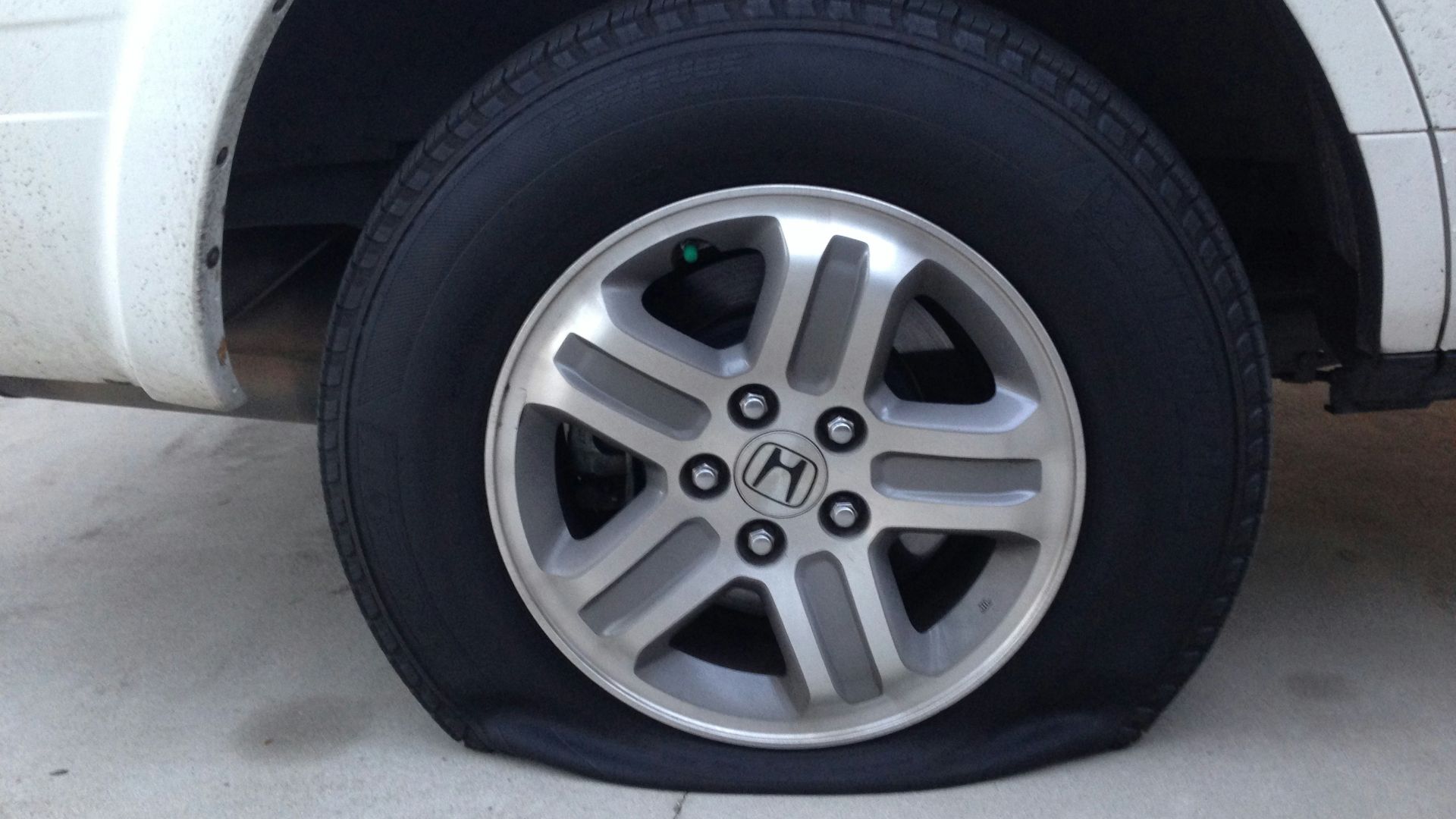 gray 5 spoke wheel with tire
