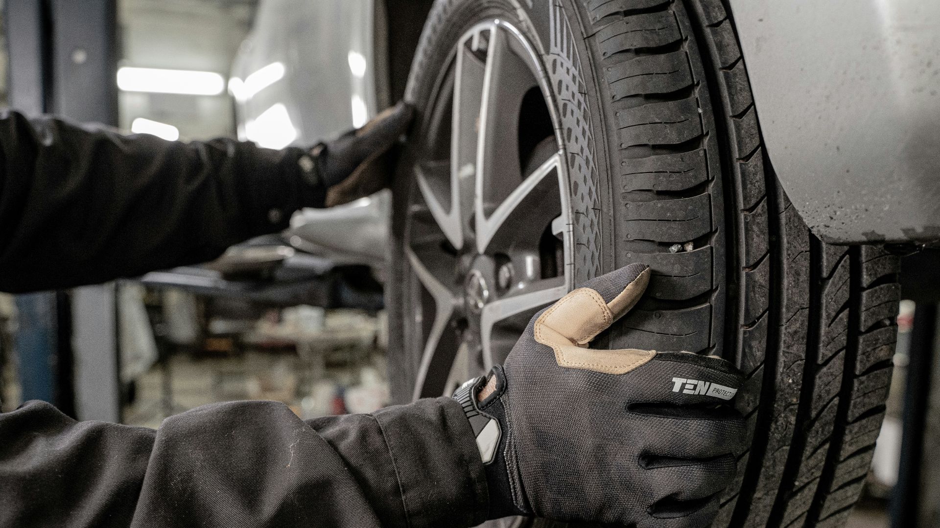 a man working on a tire in a garage