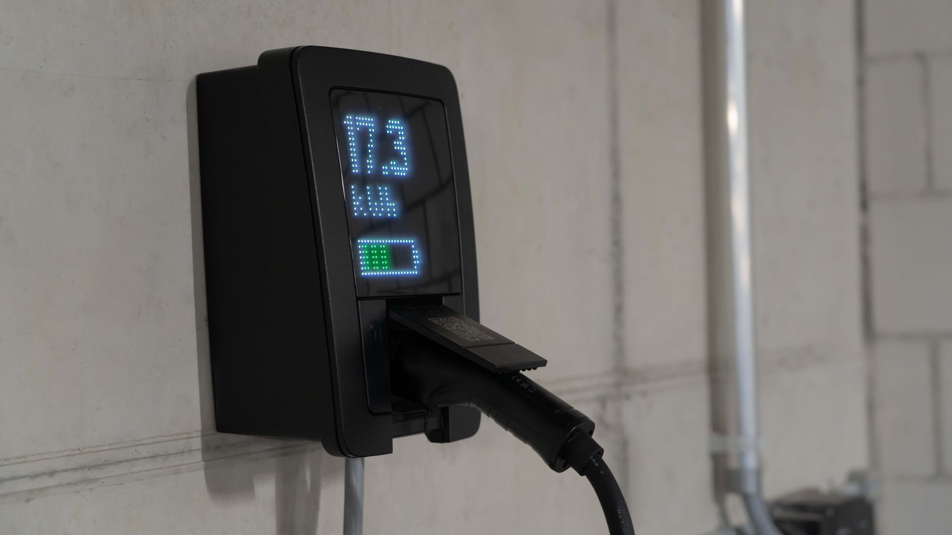 Detailed view of an electric vehicle charging station indoors, showcasing charging technology.