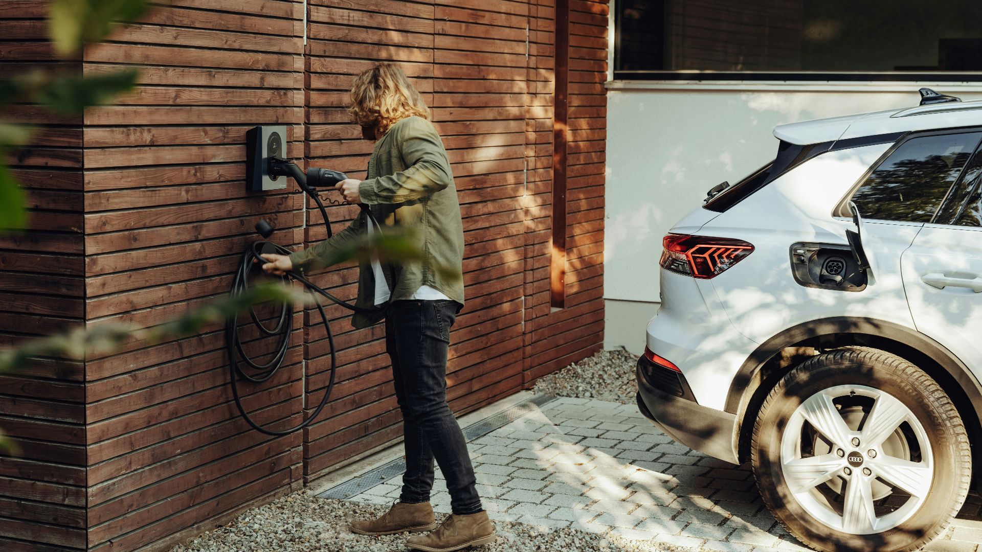 a woman is using a power washer on a brick wall