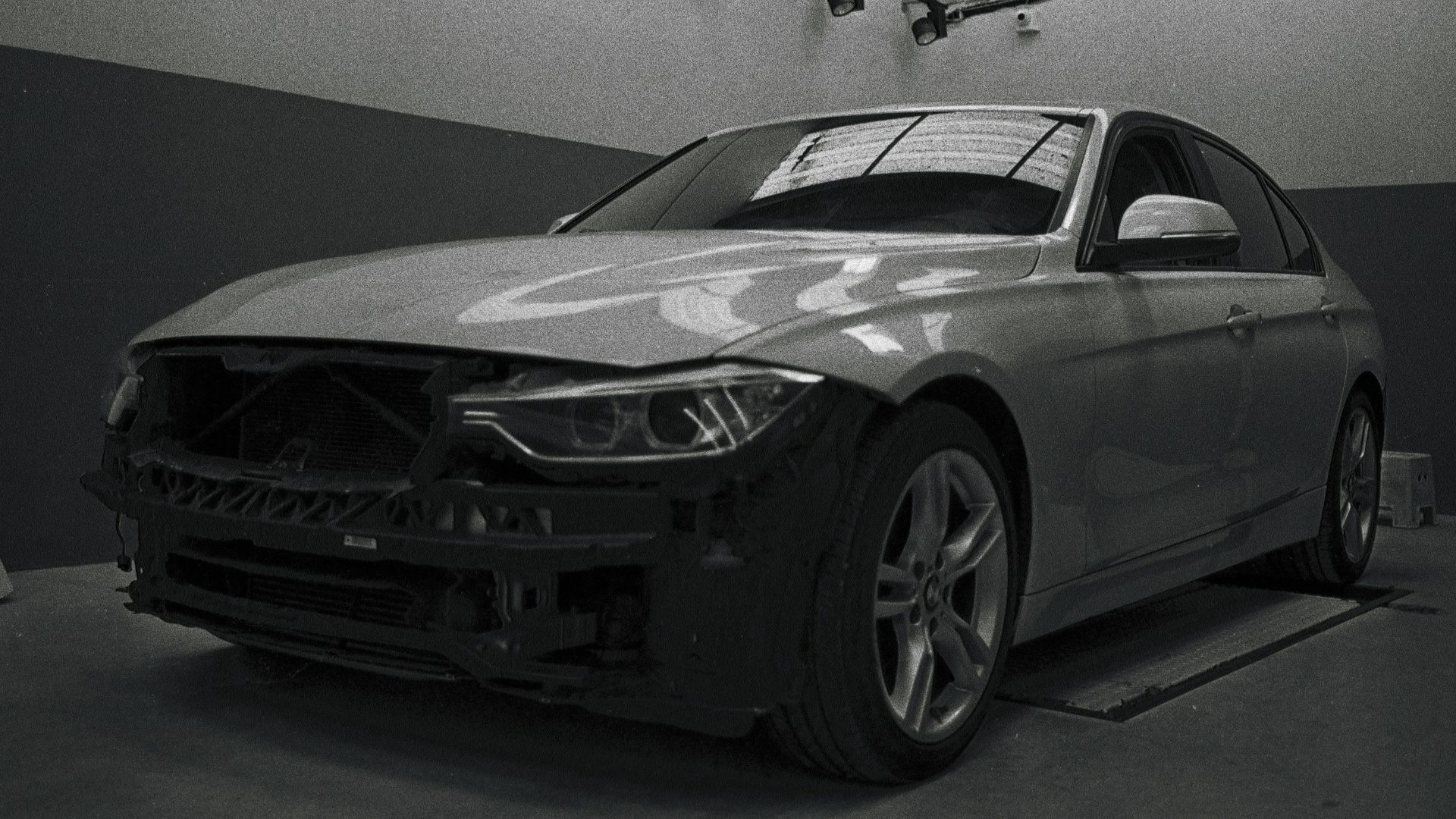 a black and white photo of a car in a garage