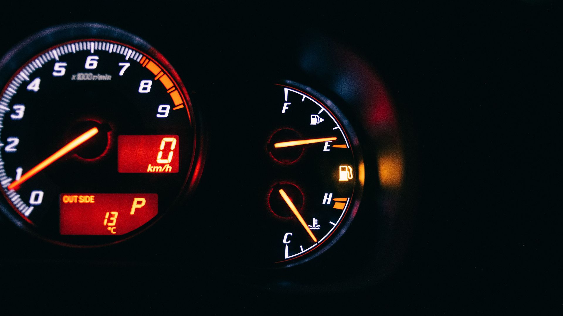 Modern control and measuring devices with arrows indicating numbers and letters on scales in automobile on black background