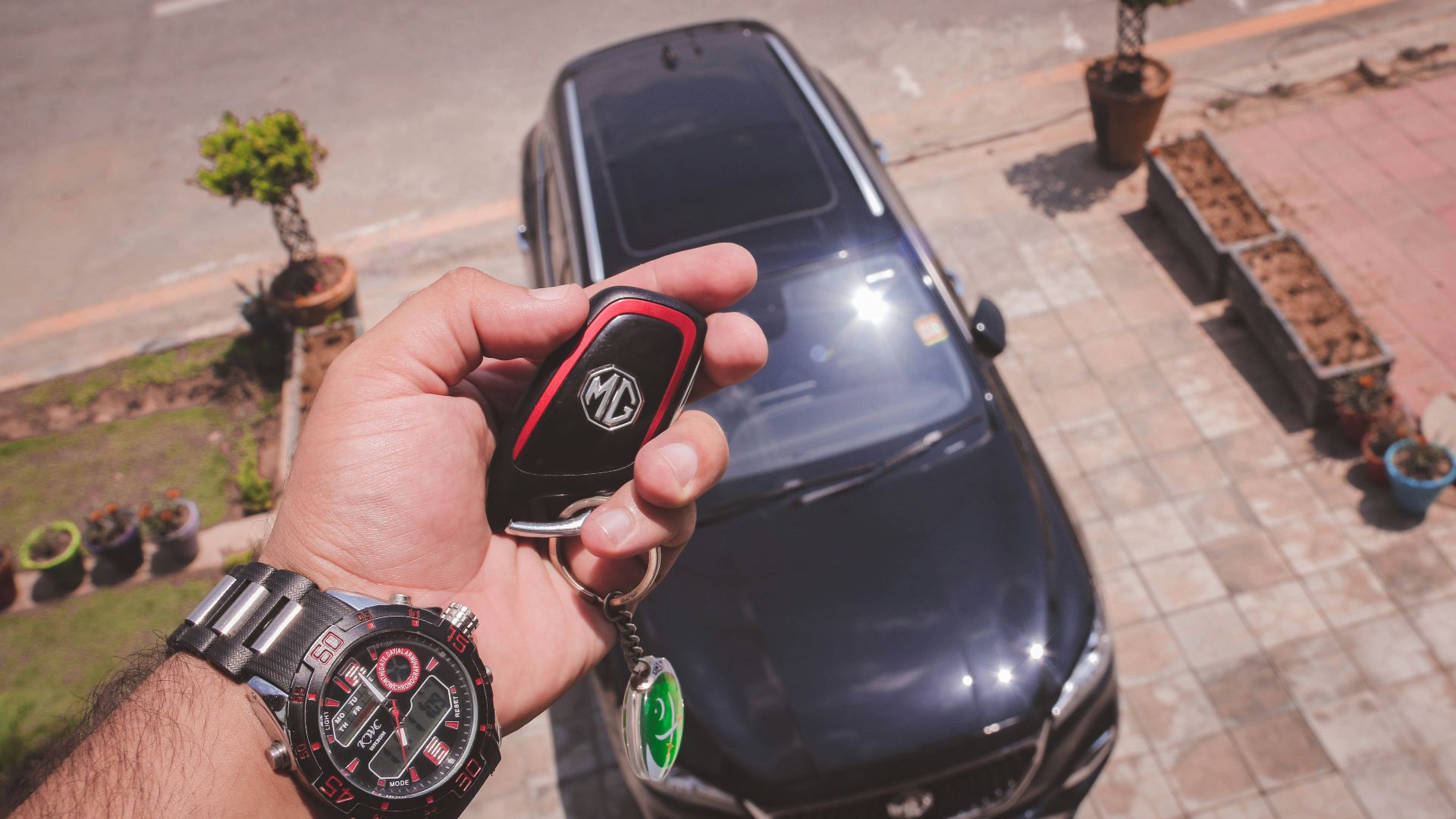 person holding black and red round digital watch