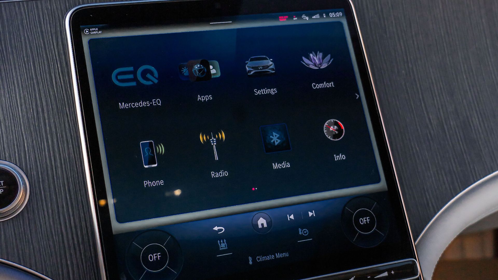 Interior view of Mercedes-Benz EQS featuring advanced touchscreen controls in a luxury setting.