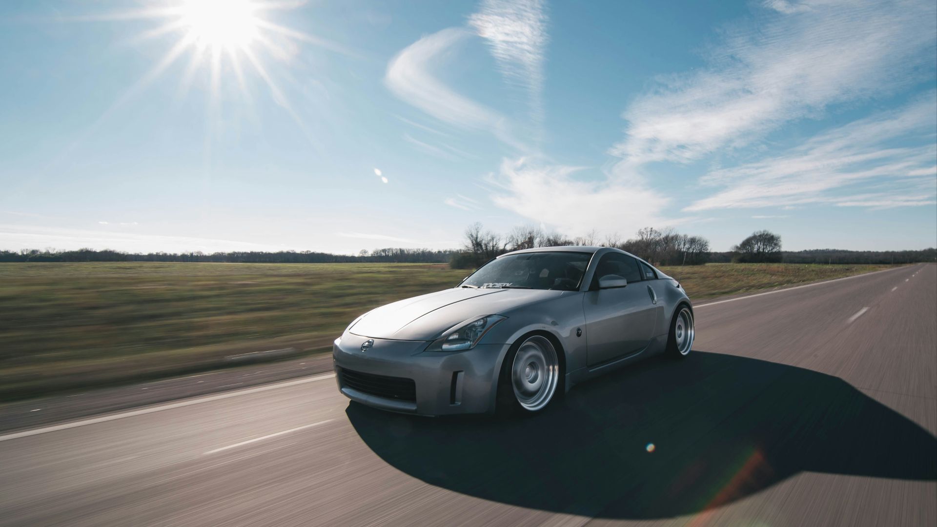 photo of gray coupe on road at daytime