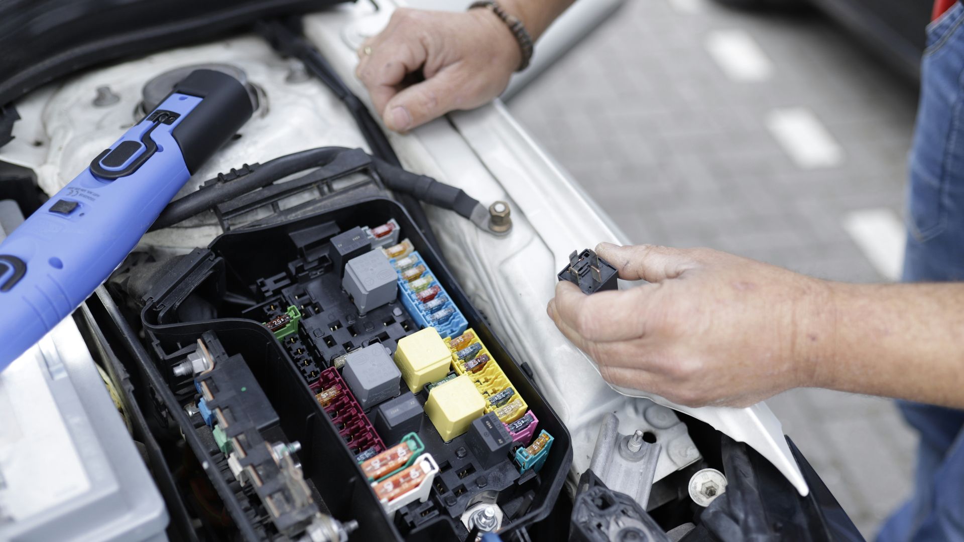 a man is working on a car's engine