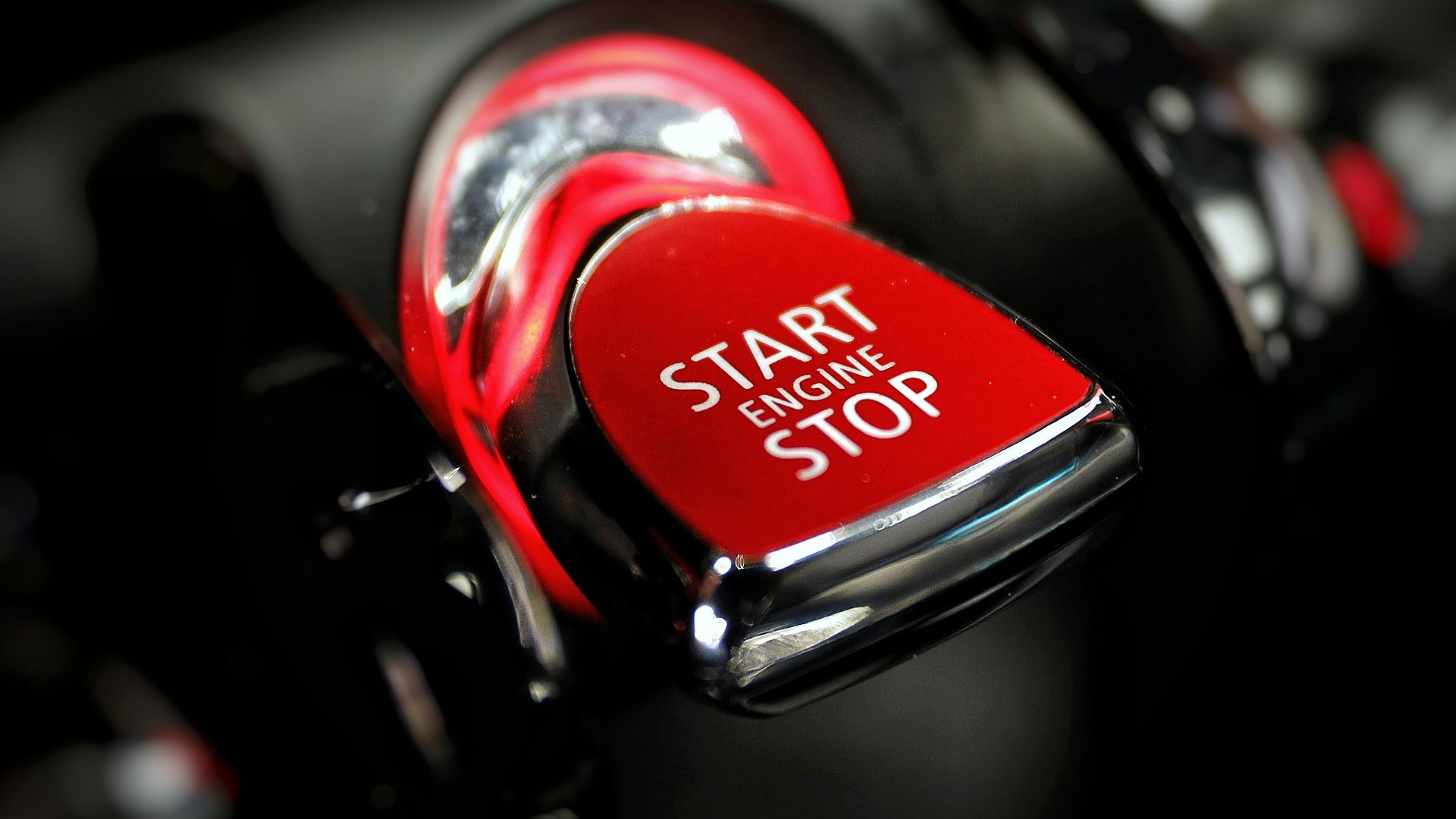 a close up of a red stop button on a car