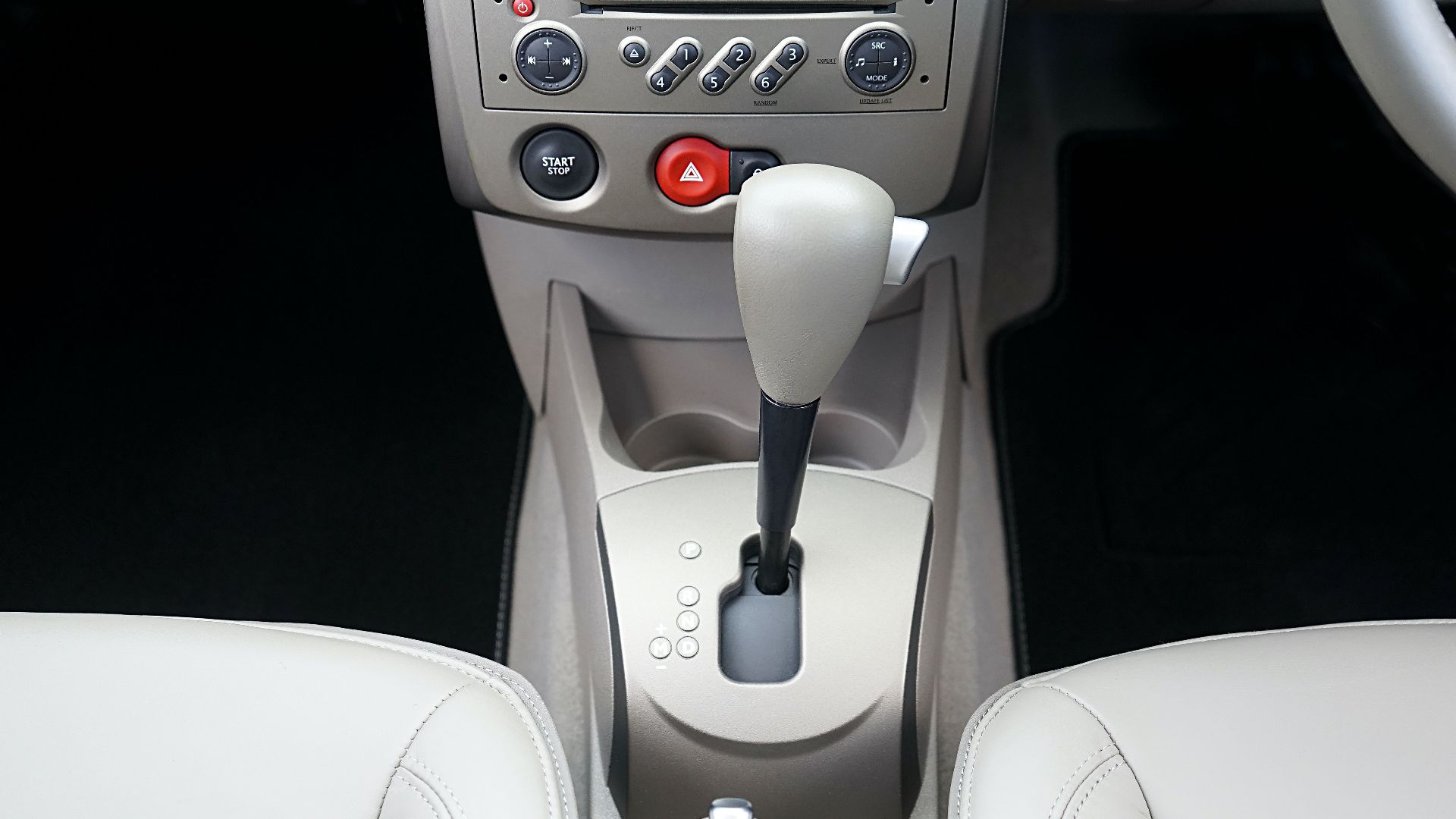 Close-up view of a car's center console featuring a gear shift and control buttons.