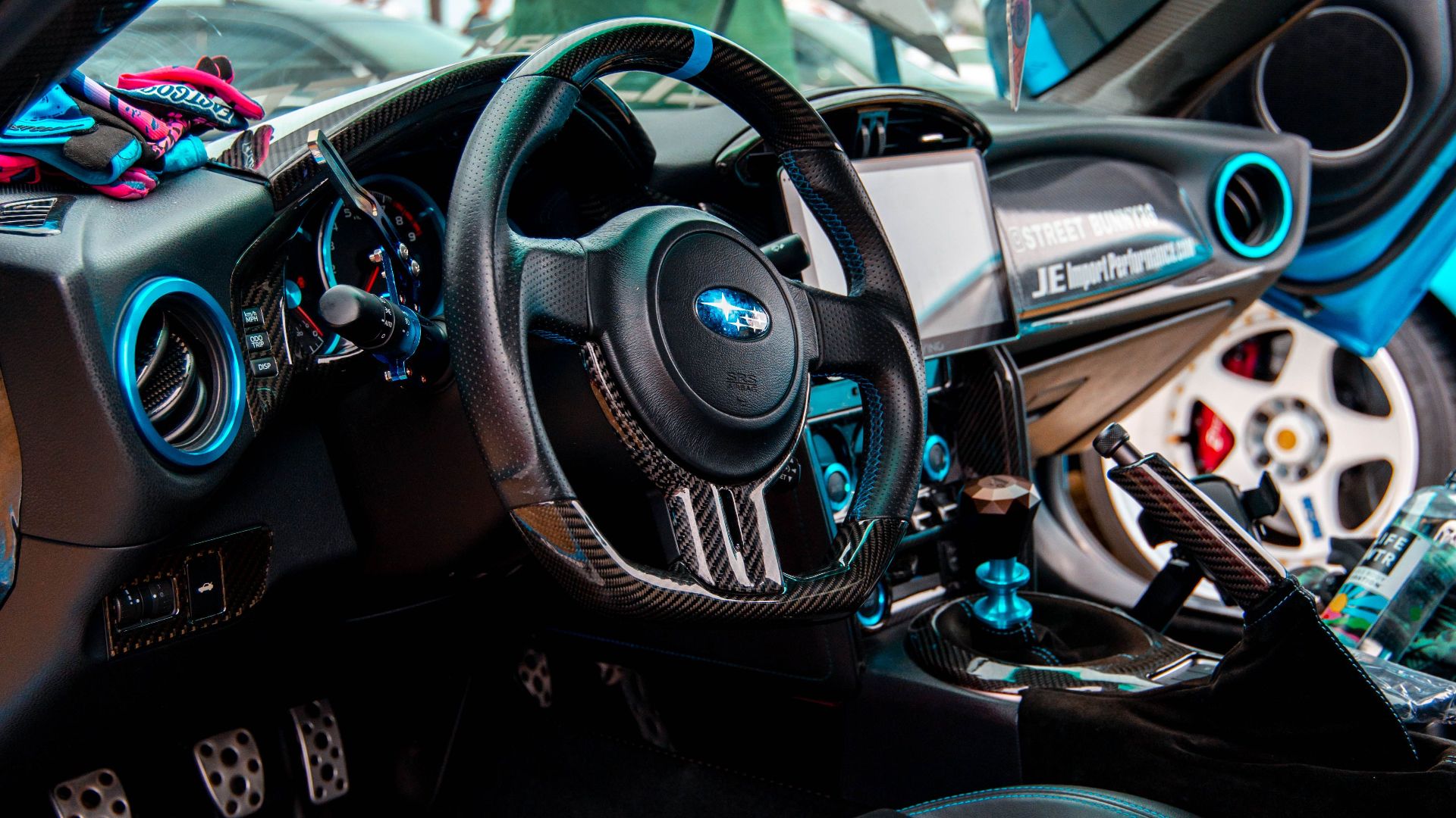 Close-up of a vibrant sports car interior featuring modern racing details and advanced dashboard.