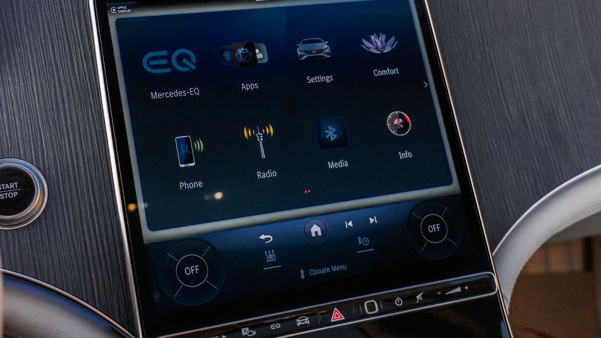 Interior view of Mercedes-Benz EQS featuring advanced touchscreen controls in a luxury setting.