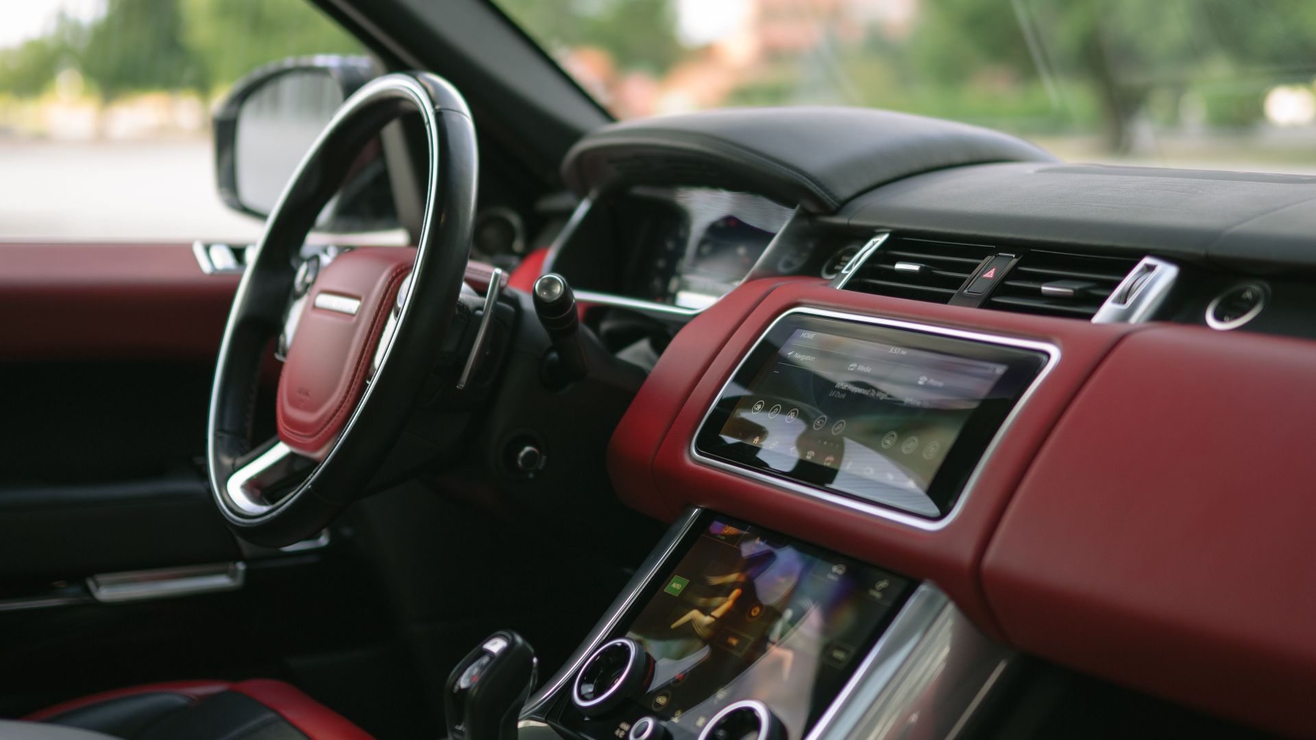 Luxury SUV interior featuring leather seats and a modern dashboard with touchscreen display.