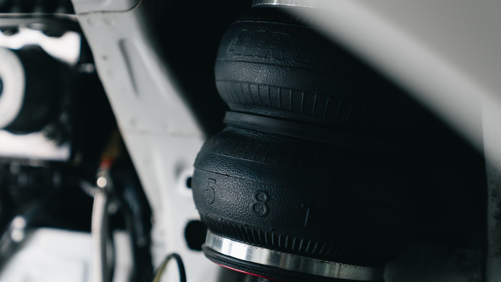 Detailed view of a vehicle's air suspension component with focus on texture and design.