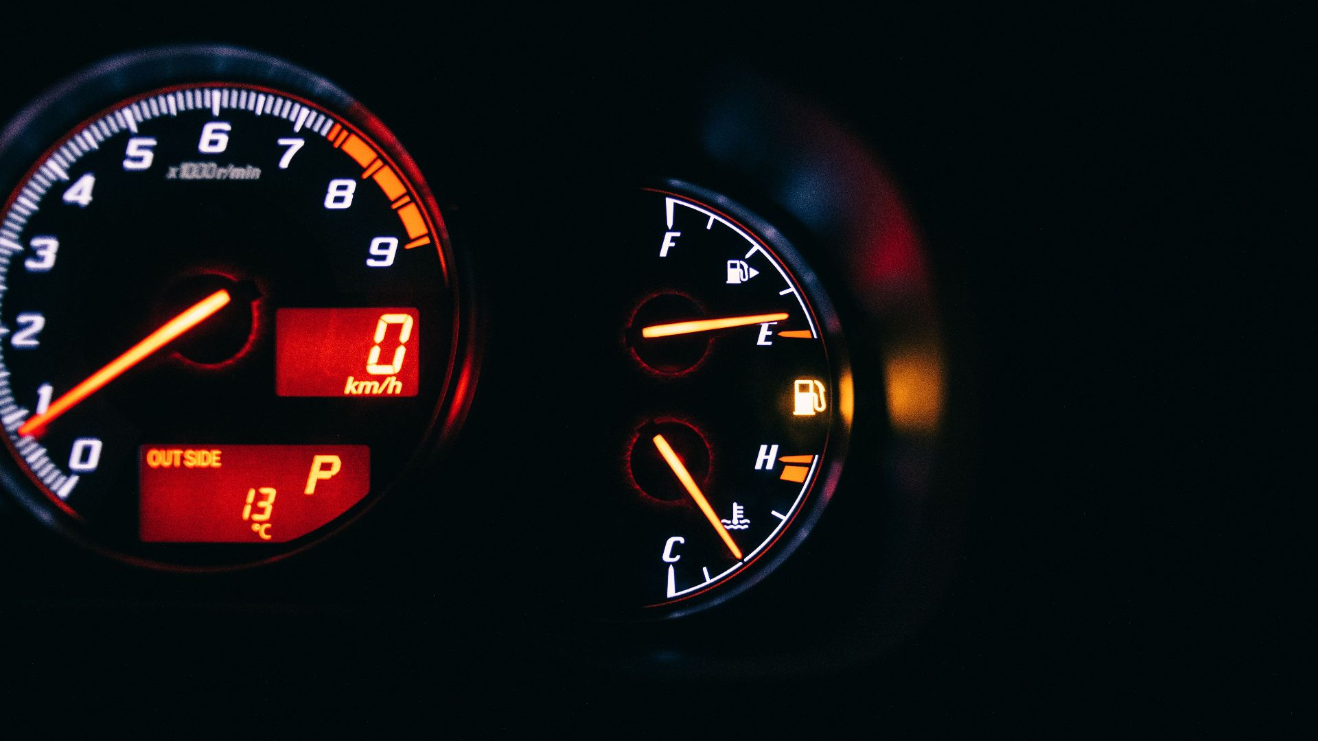 Modern control and measuring devices with arrows indicating numbers and letters on scales in automobile on black background