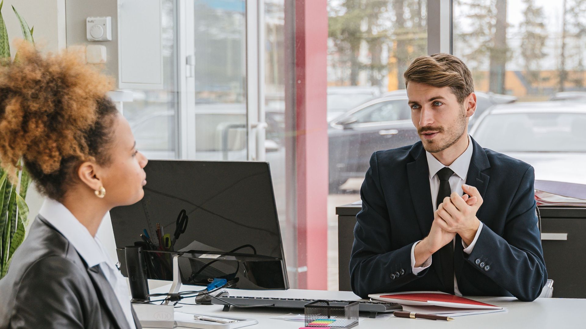 Professional meeting with clients at a modern office, discussing business solutions.