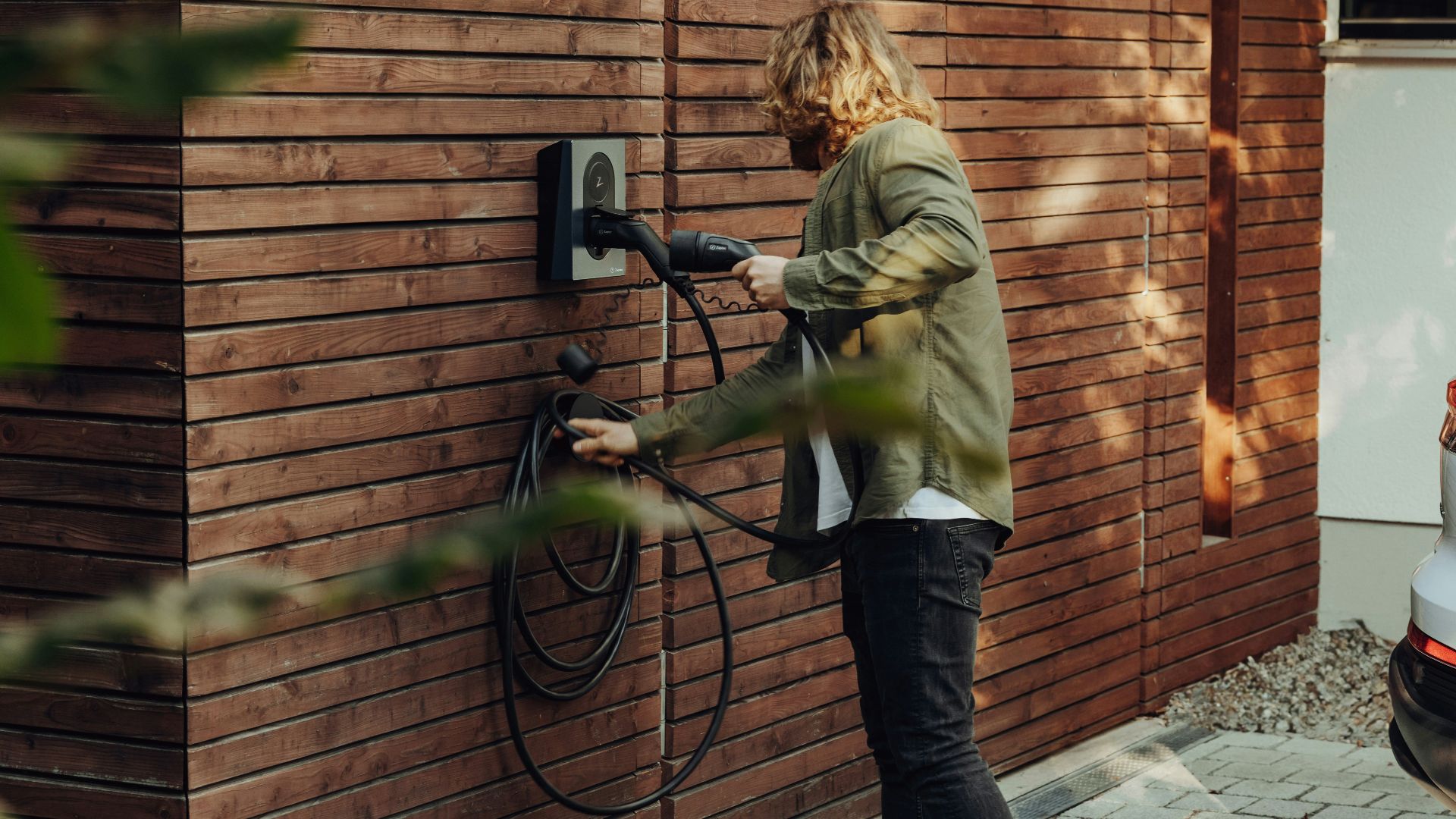 a woman is using a power washer on a brick wall