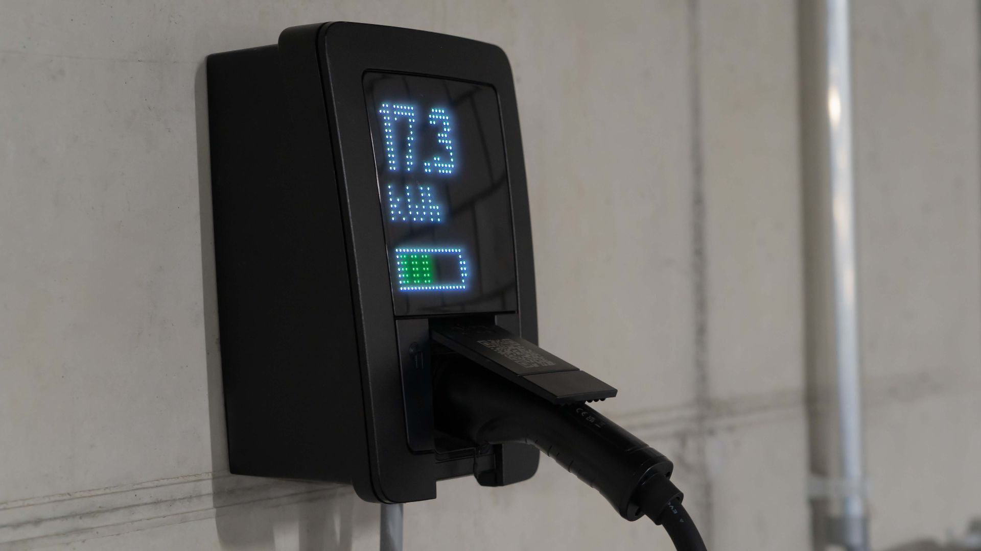 Detailed view of an electric vehicle charging station indoors, showcasing charging technology.