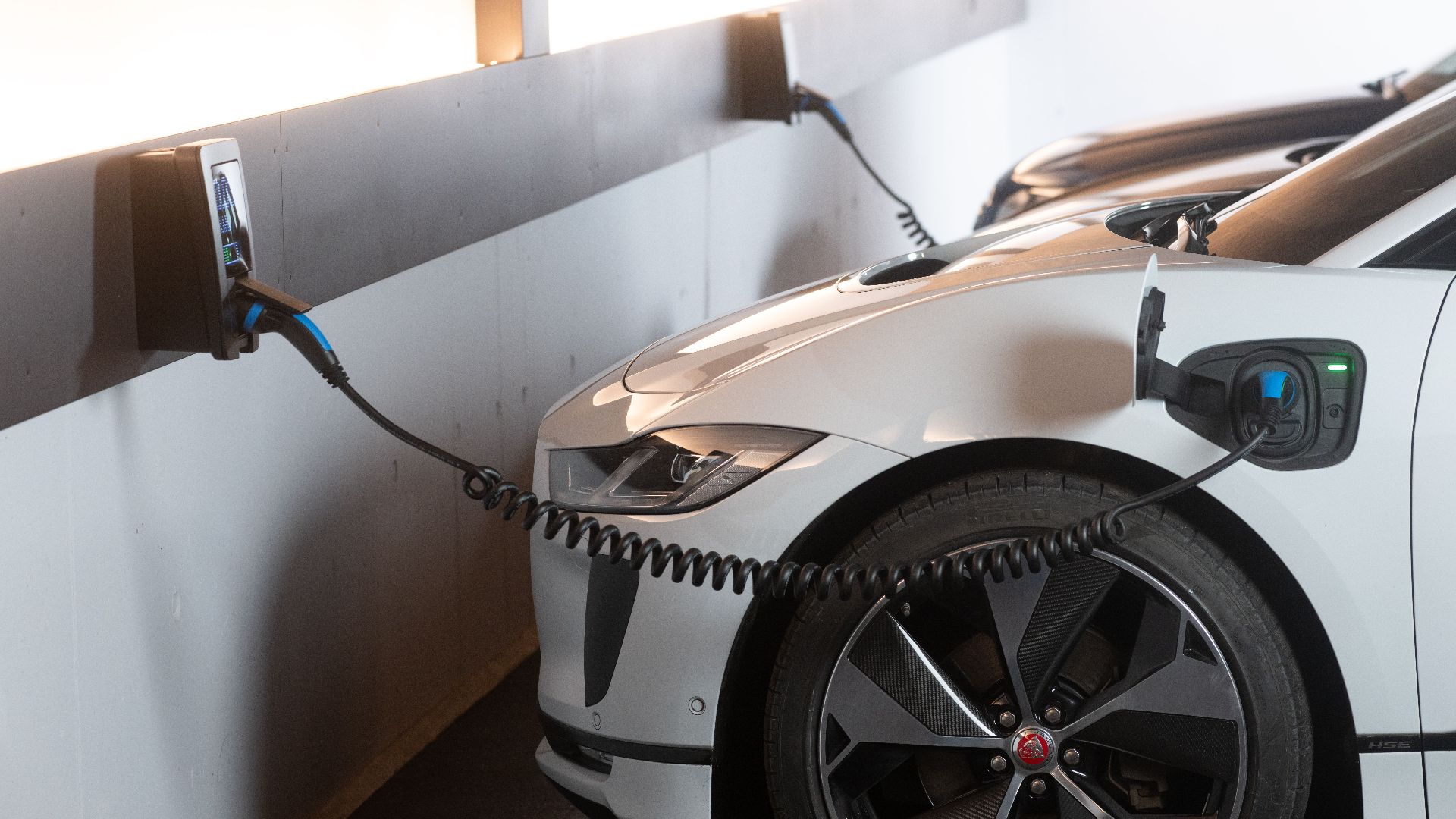 Electric car charging in a modern indoor station promoting sustainability and energy efficiency.