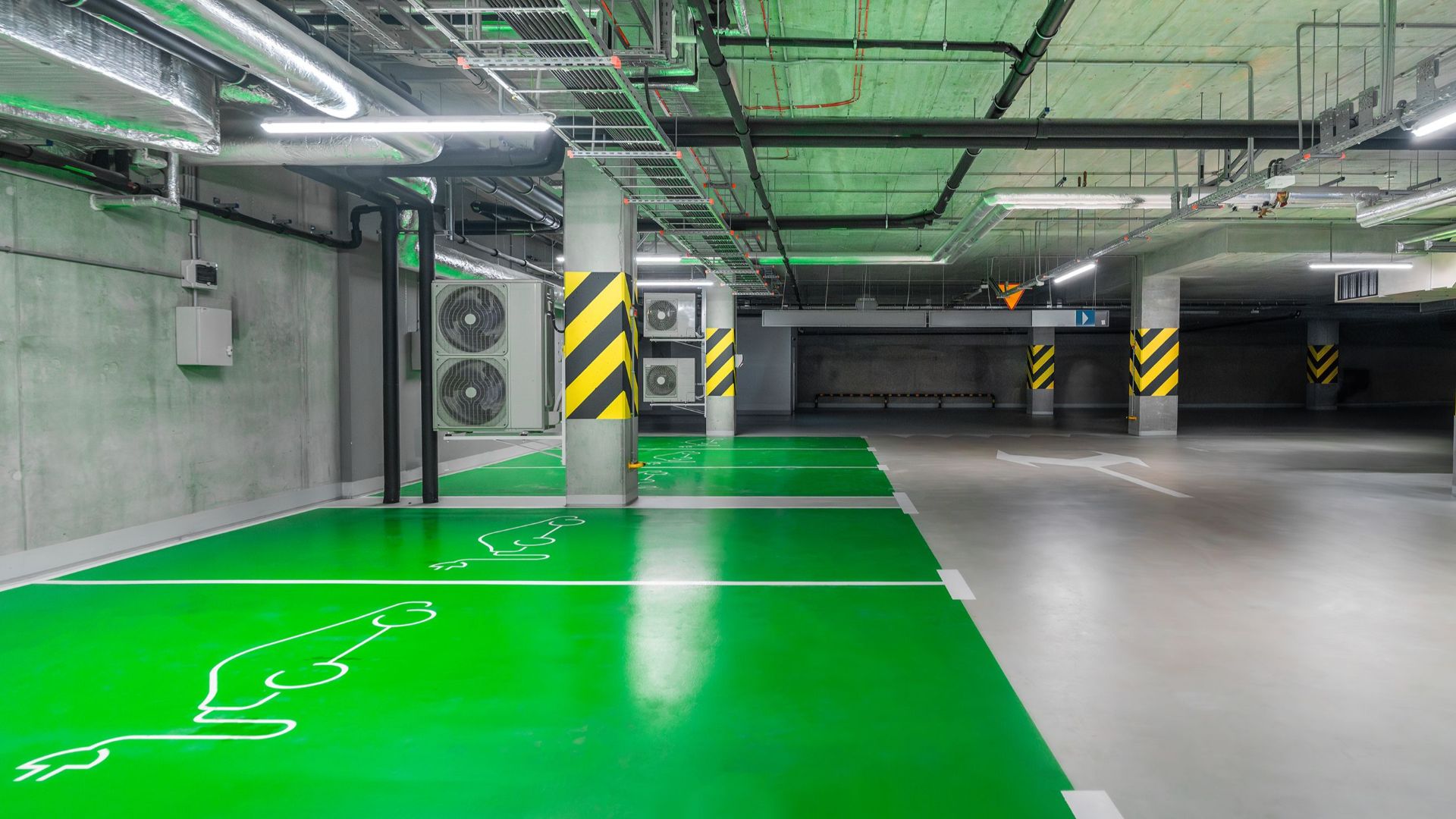 Modern green electric car charging station in an underground parking lot, eco-friendly urban solution.