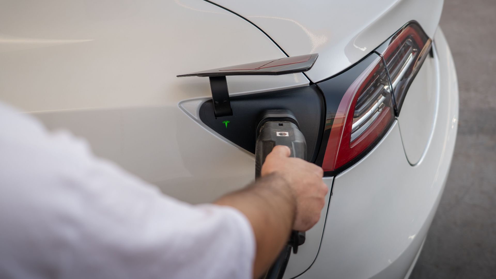Close-up of an electric car being charged, emphasizing modern sustainable technology.
