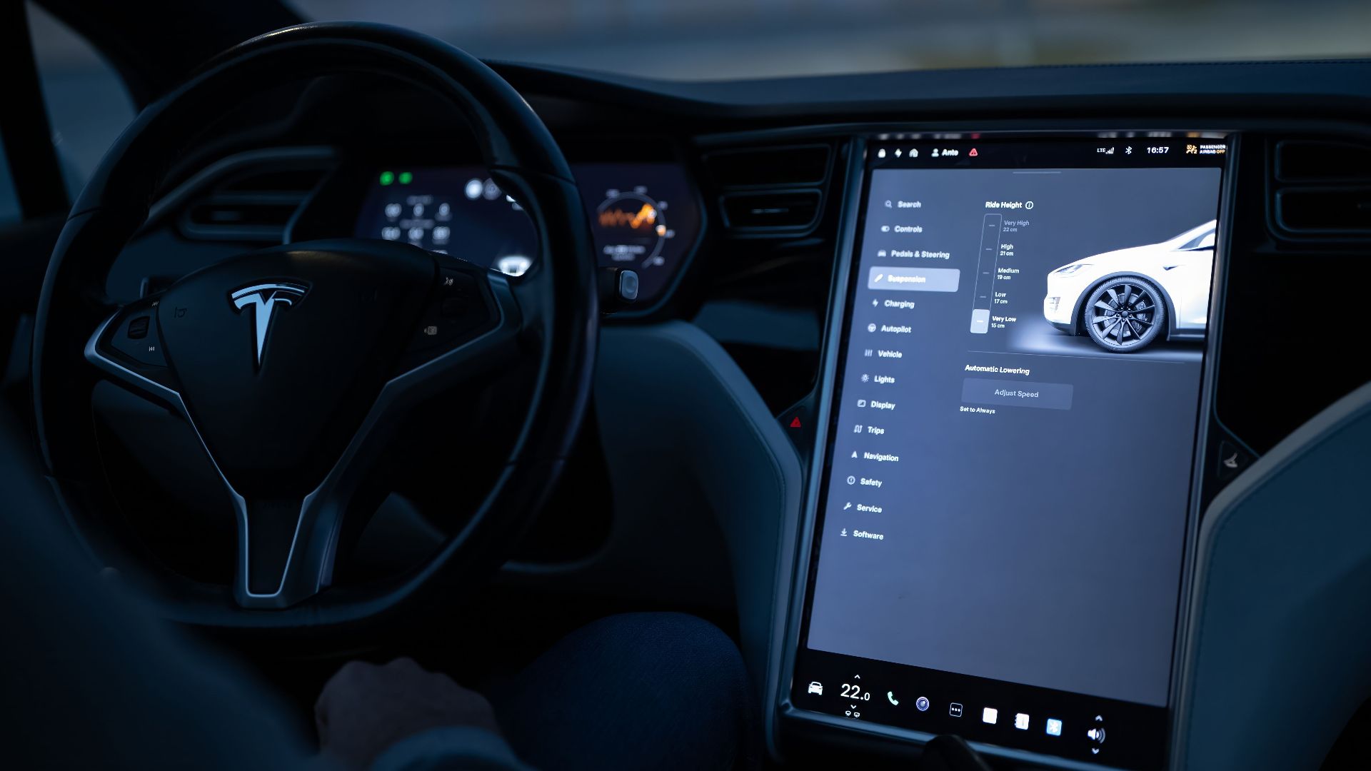 Tesla car interior showcasing advanced touchscreen display and steering controls.