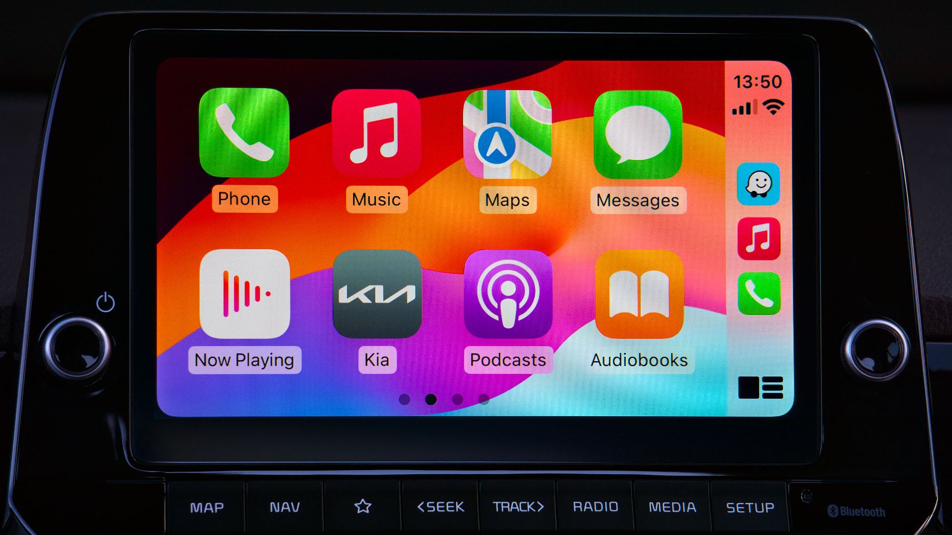 Close-up of a car's modern touchscreen display showcasing various app icons for enhanced in-car connectivity.