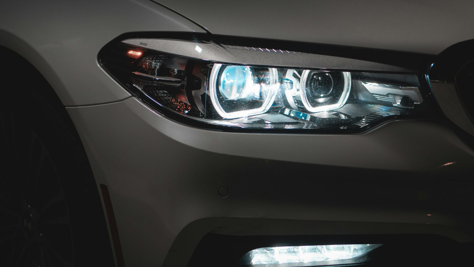 gray car with white and blue lights