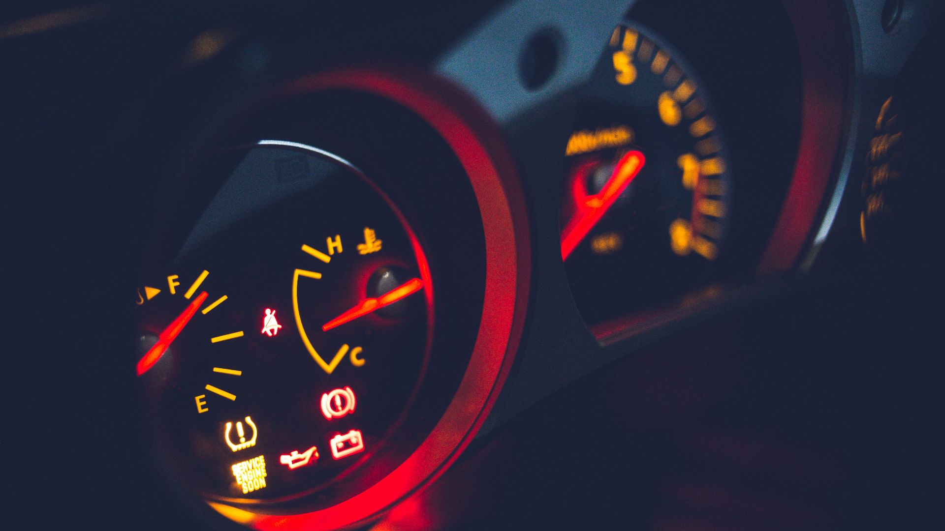 Closeup of oil pressure gauge with arrows and scale on instrument panel in modern auto