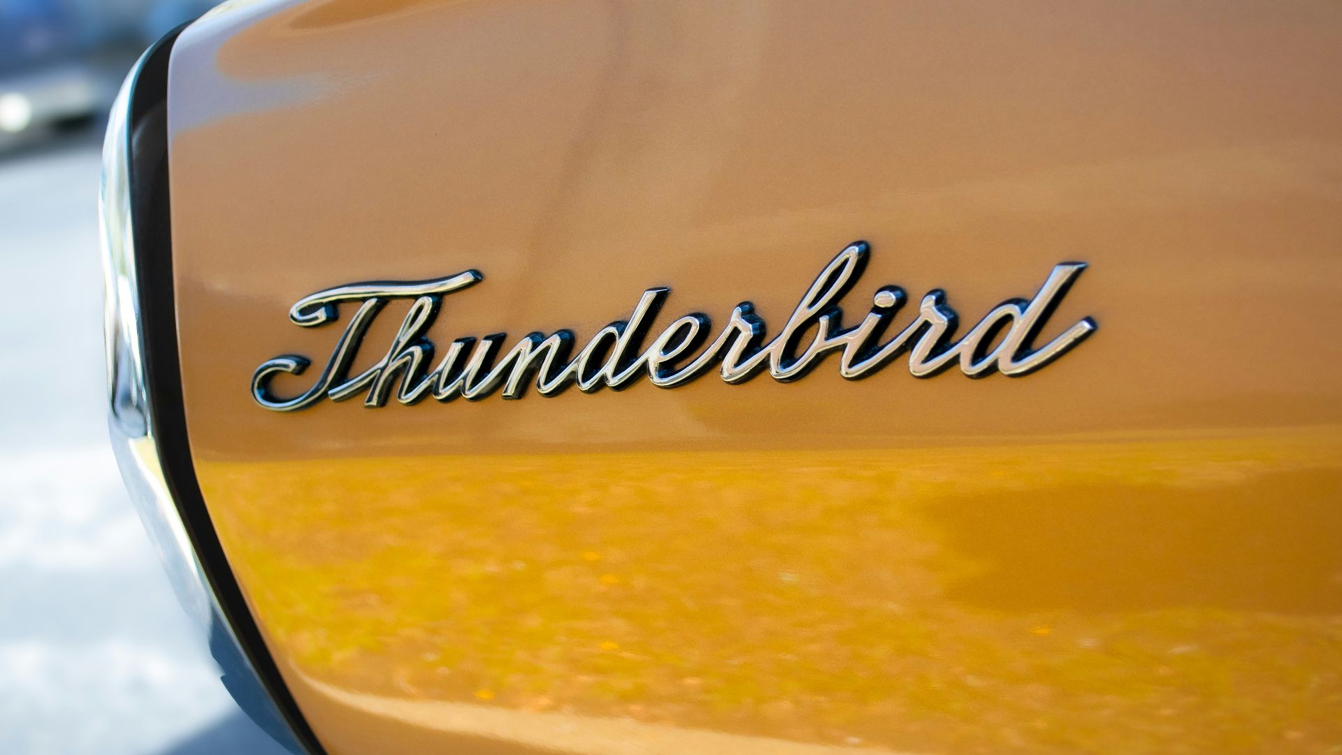 A close up of the emblem on a yellow car