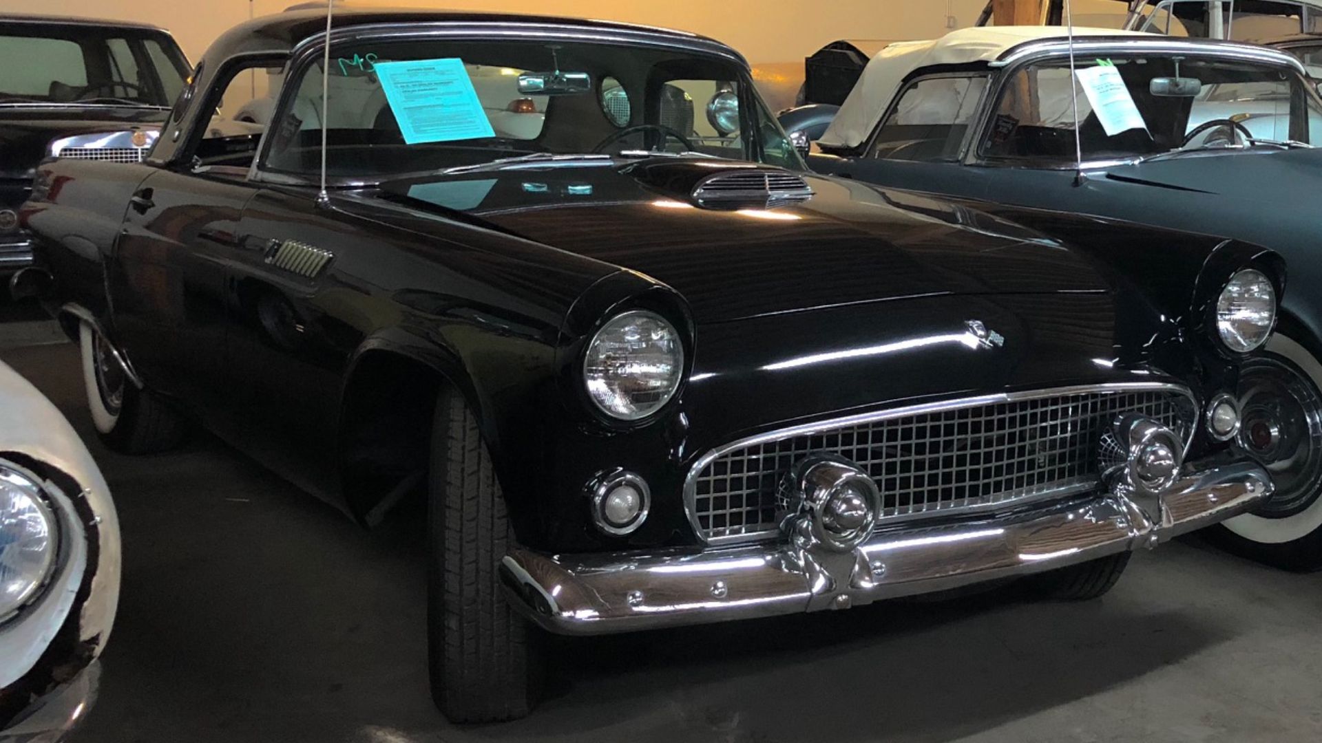 Two lovebirds (55 and 56 Thunderbirds) romantically enjoying the time of their lives in an auto storage facility.