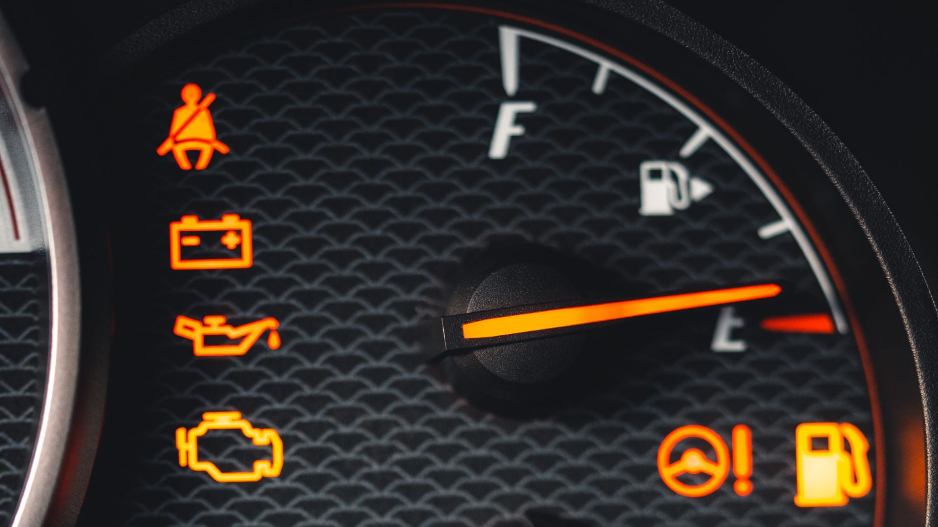 Detailed close-up of car dashboard with various warning lights illuminated.