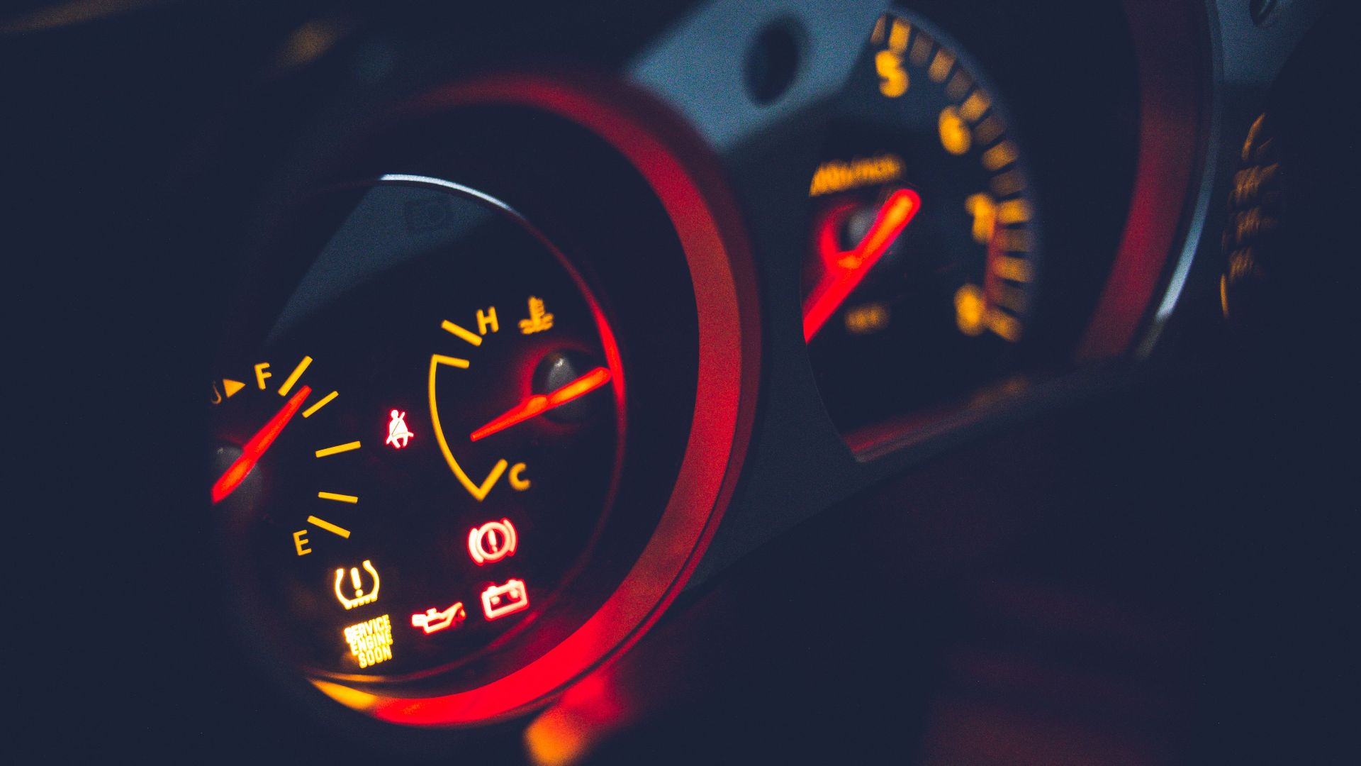 Closeup of oil pressure gauge with arrows and scale on instrument panel in modern auto